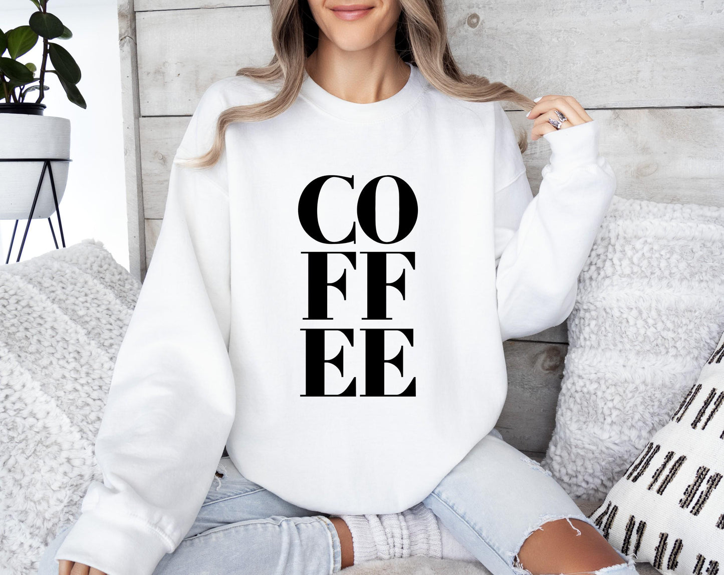 Women's bold coffee sweatshirt with simple and relatable "COFFEE" graphic print in white