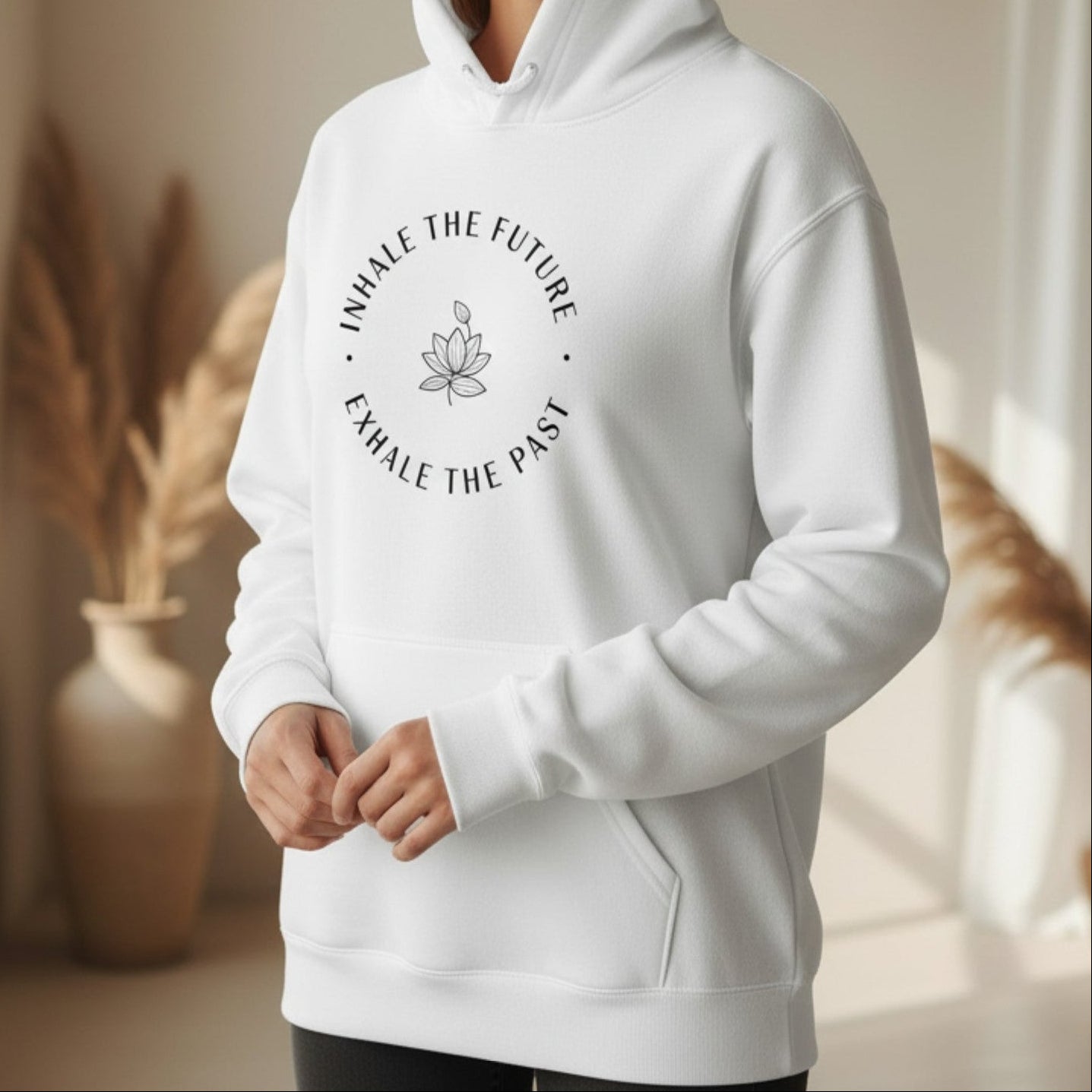White Inhale the Future Exhale the Past pullover hoodie with black lotus badge print — clean minimal mindfulness gift for the woman who exhales the past and steps into every new breath with intention