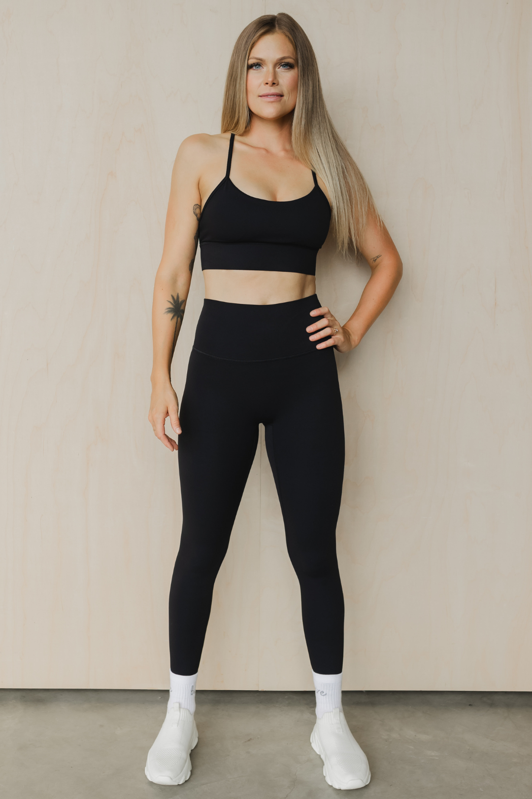 full front view of a woman wearing a barely there sports bra in black for high impact training and everyday wear