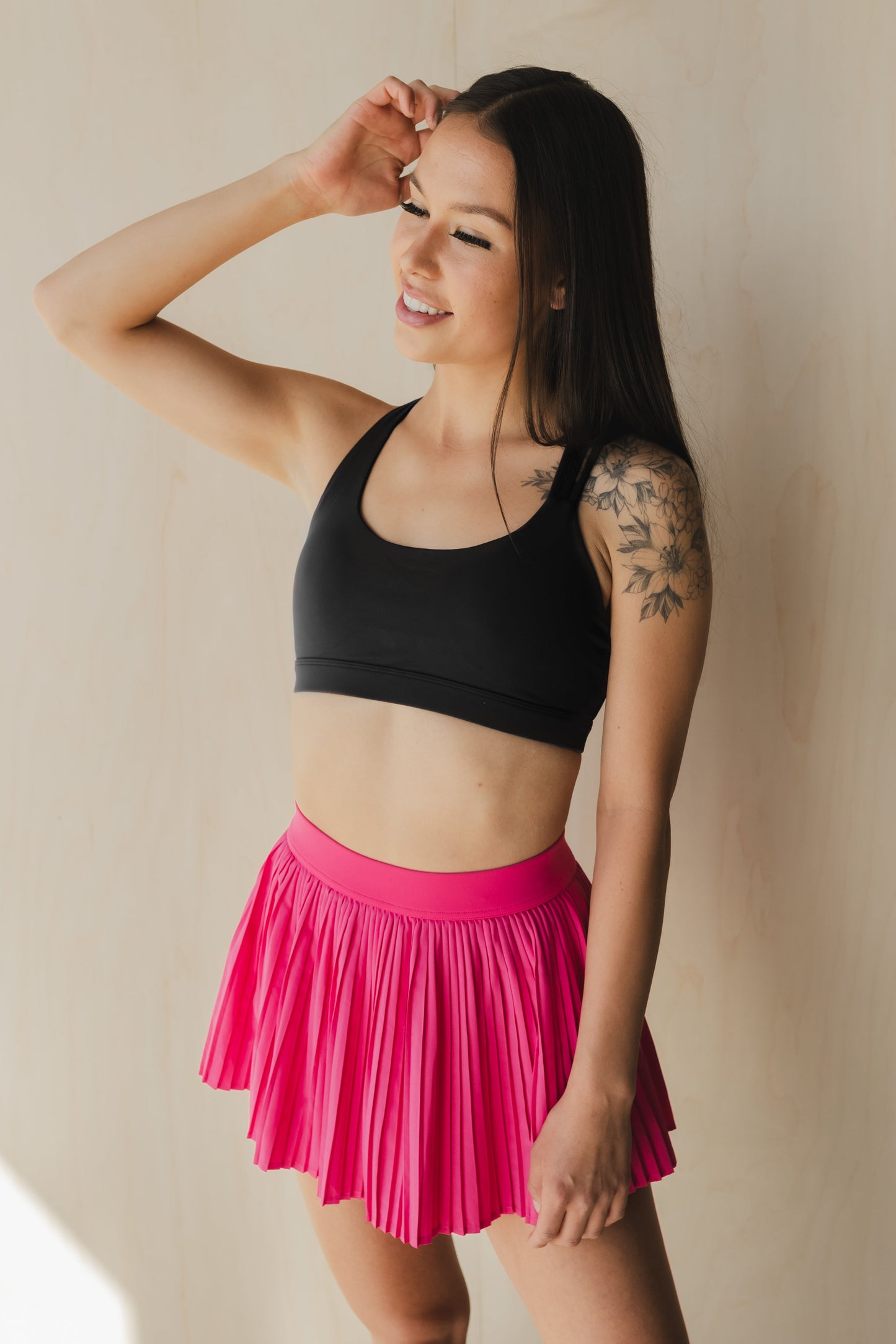 zoomed out view of a woman wearing S.F. V3 sports bra in lack for gym and high impact workouts