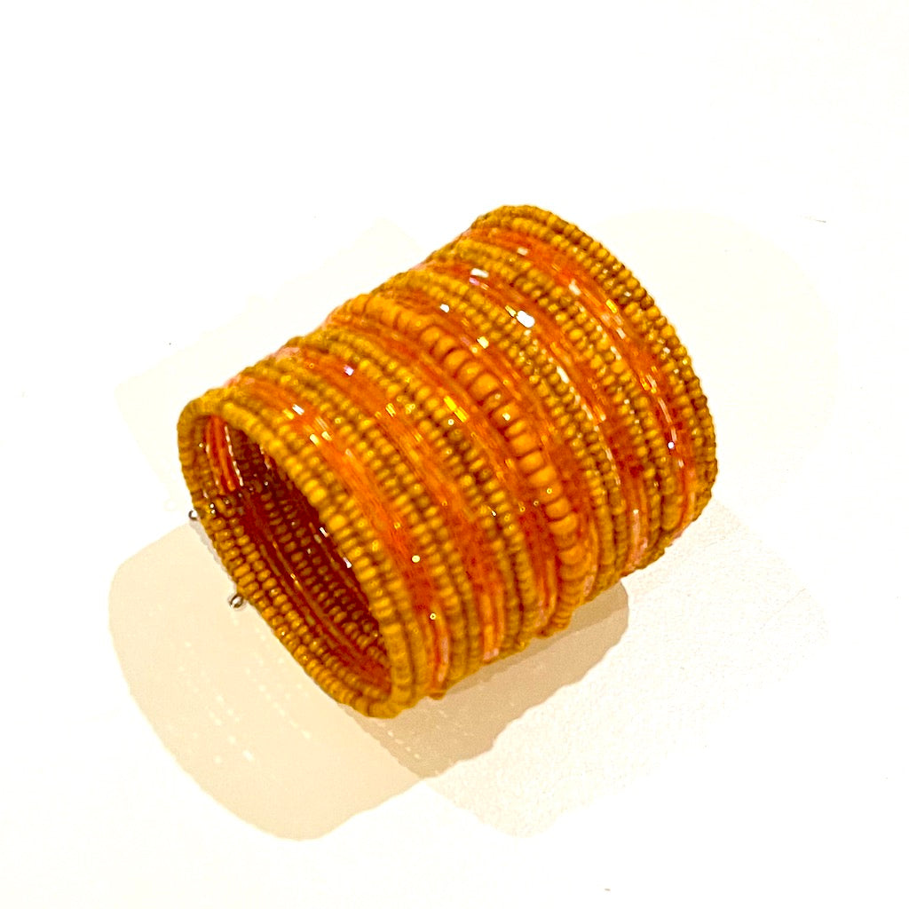 Colorful mixed bead cuff bracelet artisan handmade in orange side view
