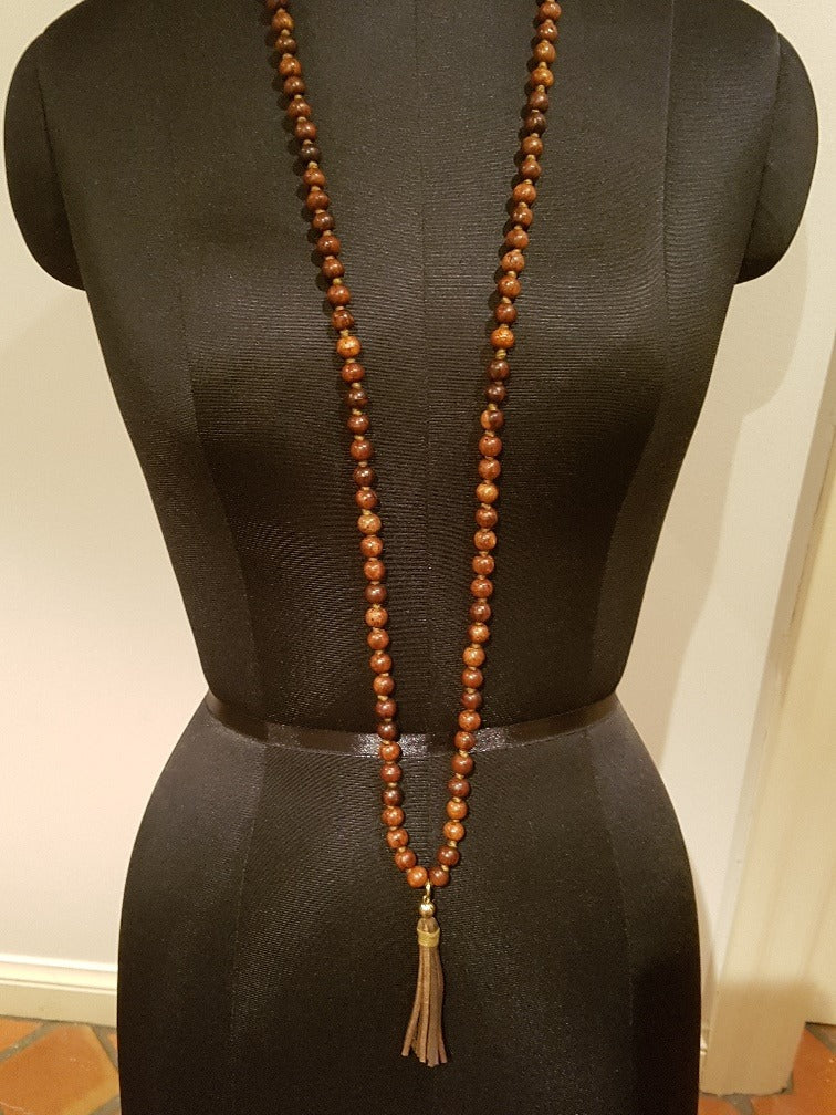 Handcrafted wooden mala necklace with natural wood beads and tassel — bohemian spiritual jewelry made in India