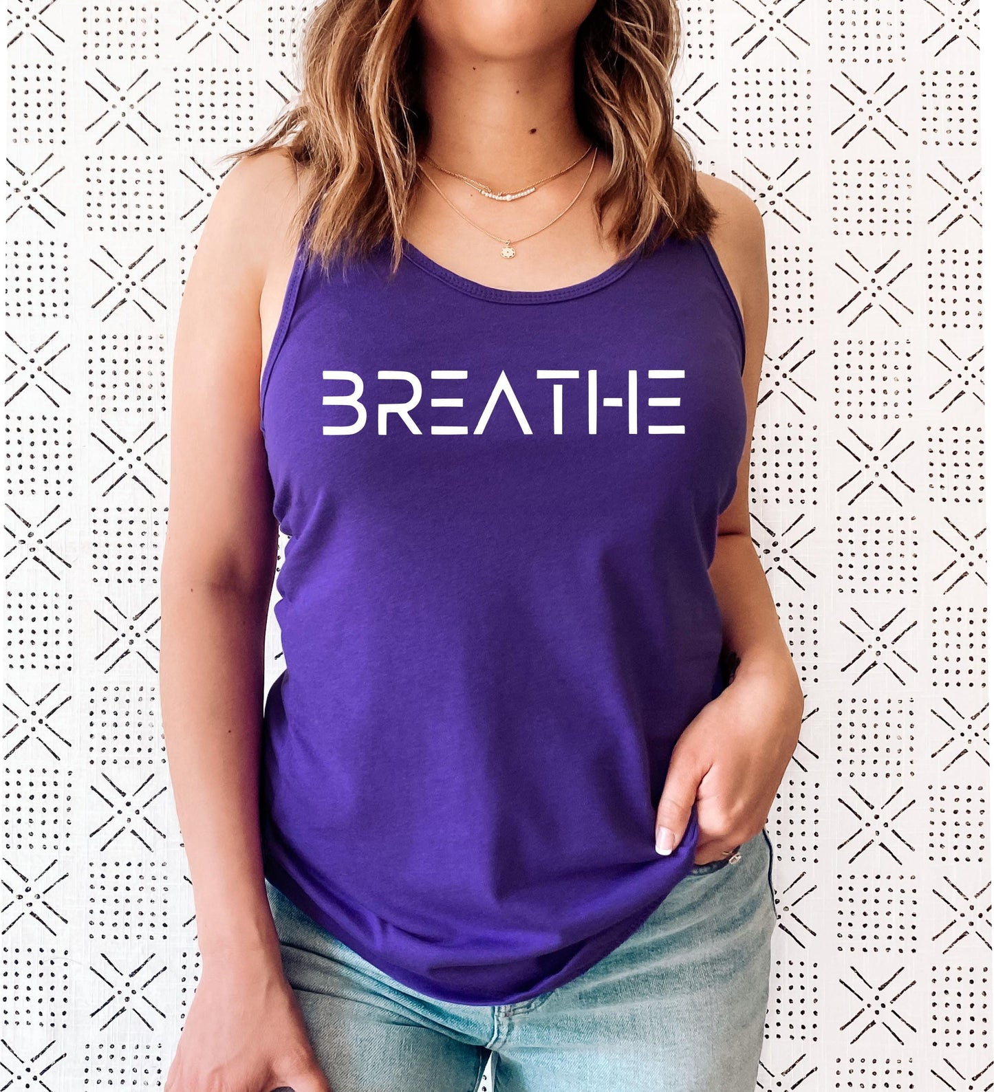 BREATHE yoga tank top close-up showing soft fabric and bold graphic detail in purple