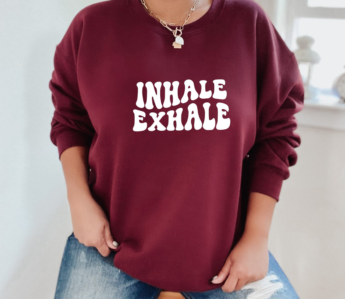 Women's breathwork yoga sweatshirt with peaceful "Inhale Exhale" graphic print in maroon