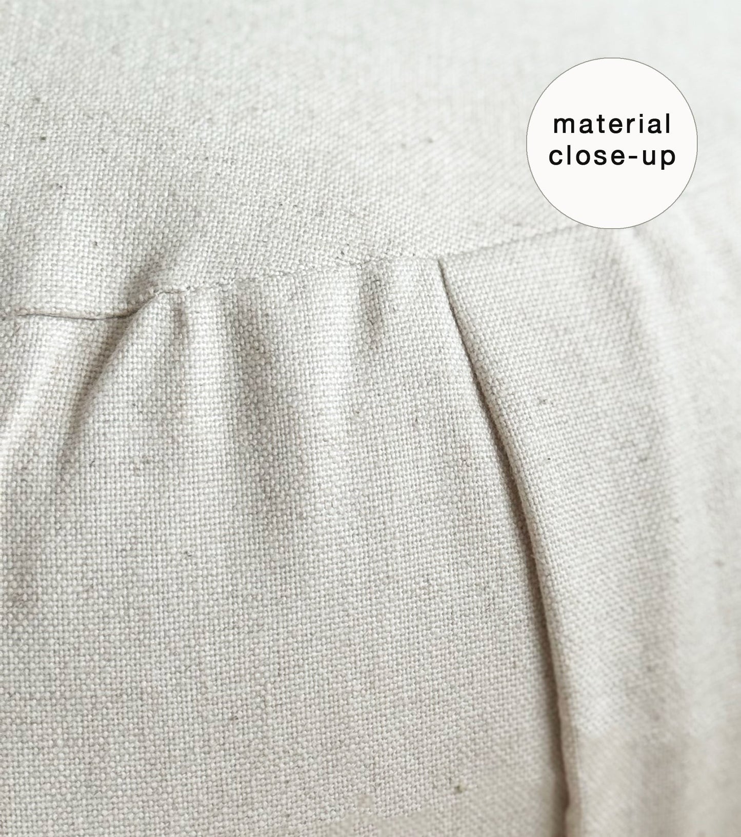Close-up of beige fabric of a meditation cushion with a 'material close-up' label.