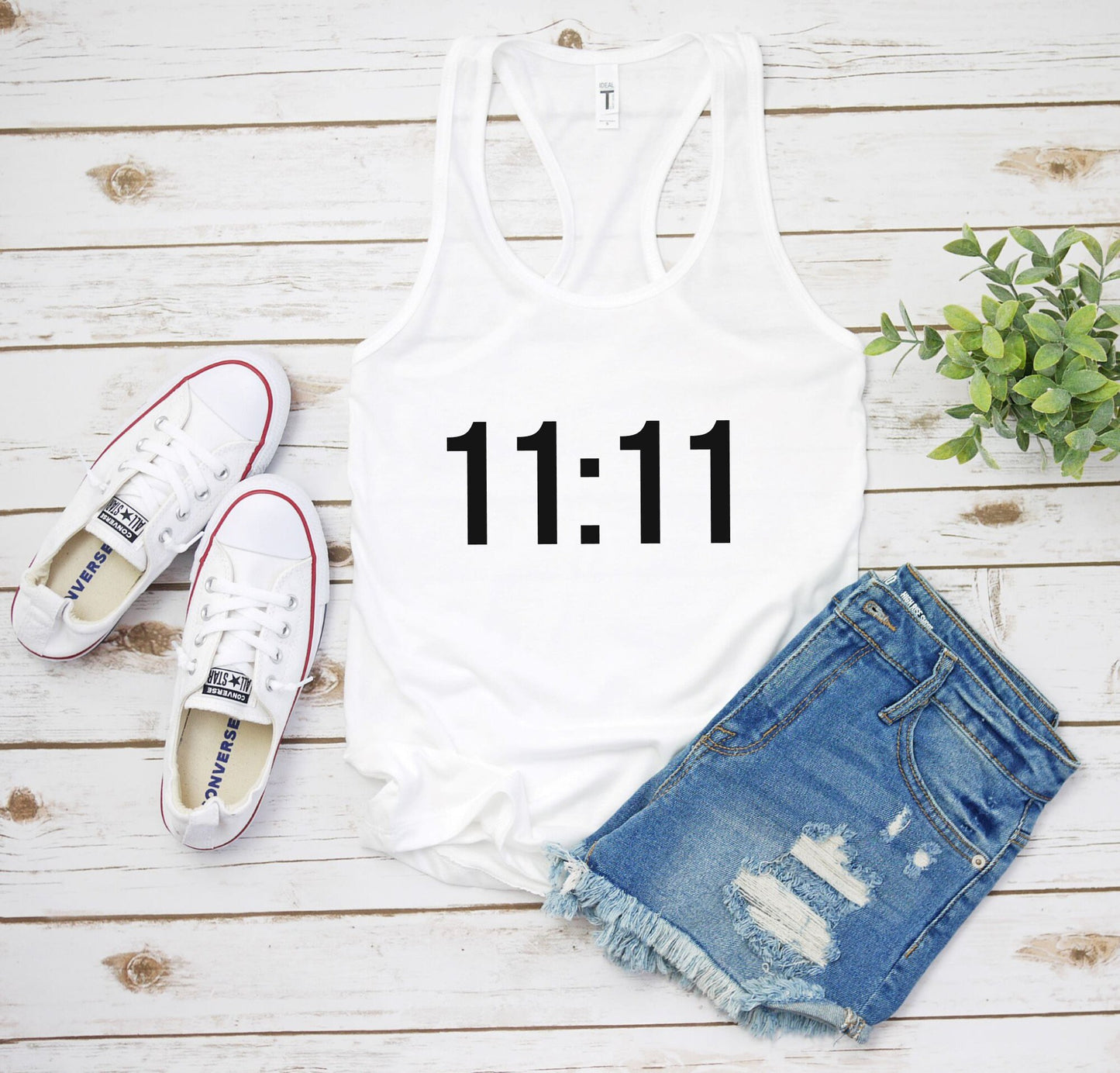 1111 racerback tank top close-up showing soft fabric and angel number print detail in white