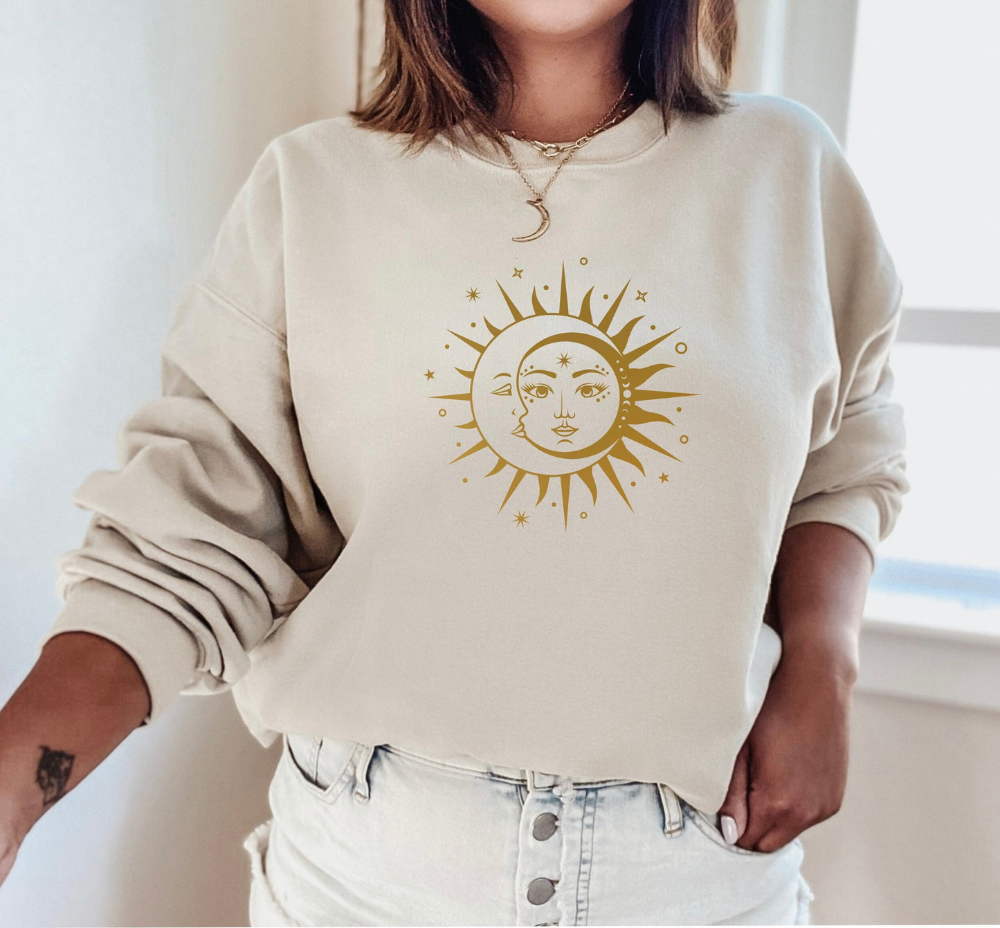 Sun and Moon Yin Yang sweatshirt close-up showing celestial graphic detail in beige
