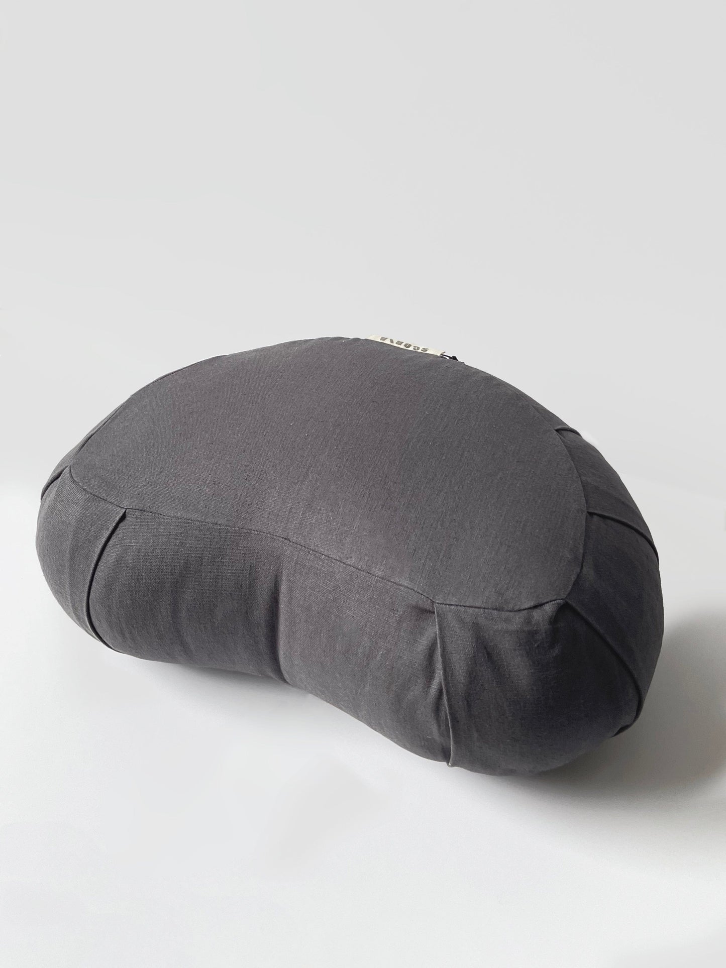 Gray yoga bolster pillow on a light gray background