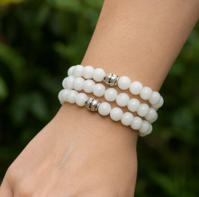 Stacked white jasper gemstone bead bracelets worn on wrist — healing crystal bracelets and natural stone jewelry for women