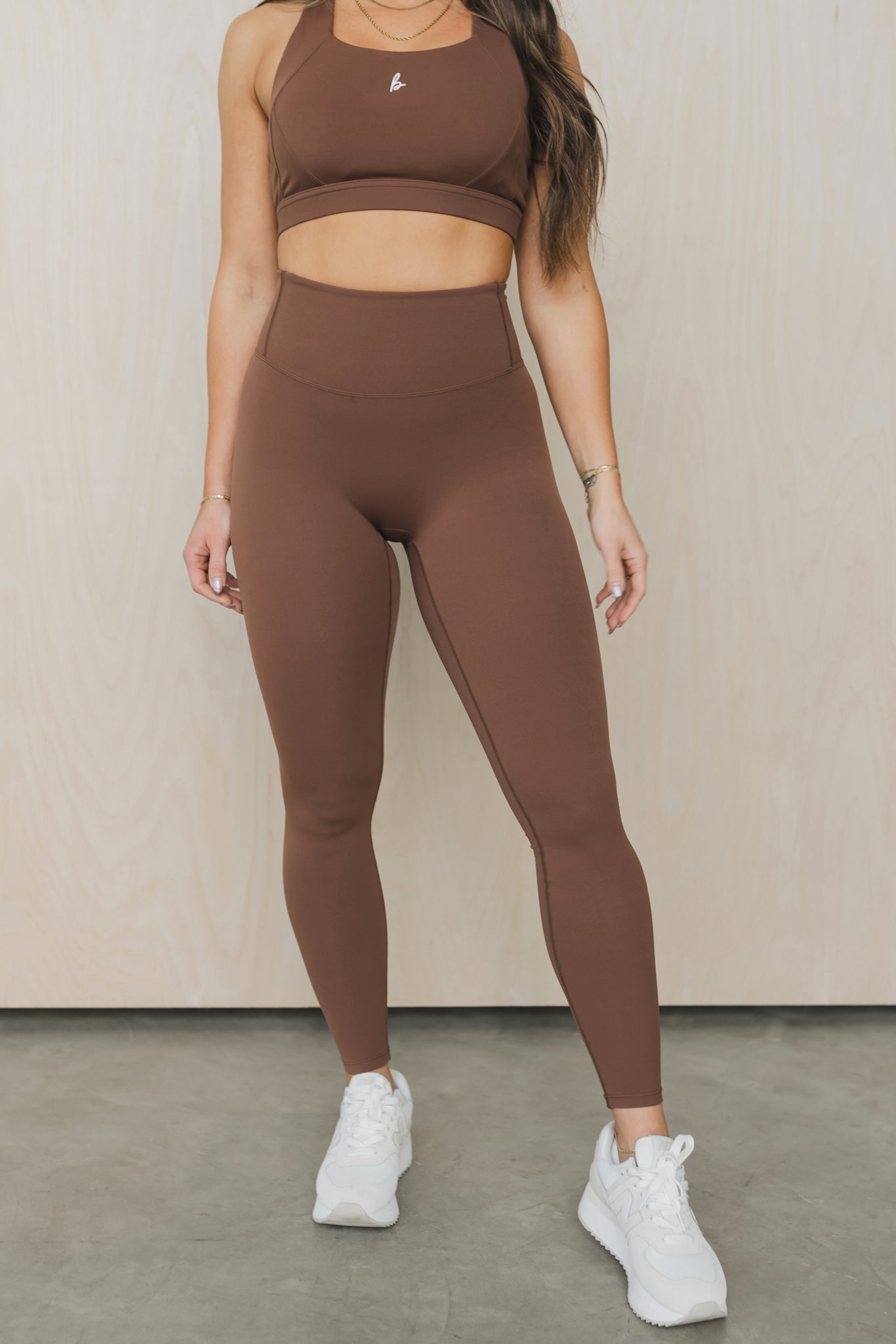 front view of a woman wearing 27 inch fight or flight leggings in caramel brown for loungewear and athleisure