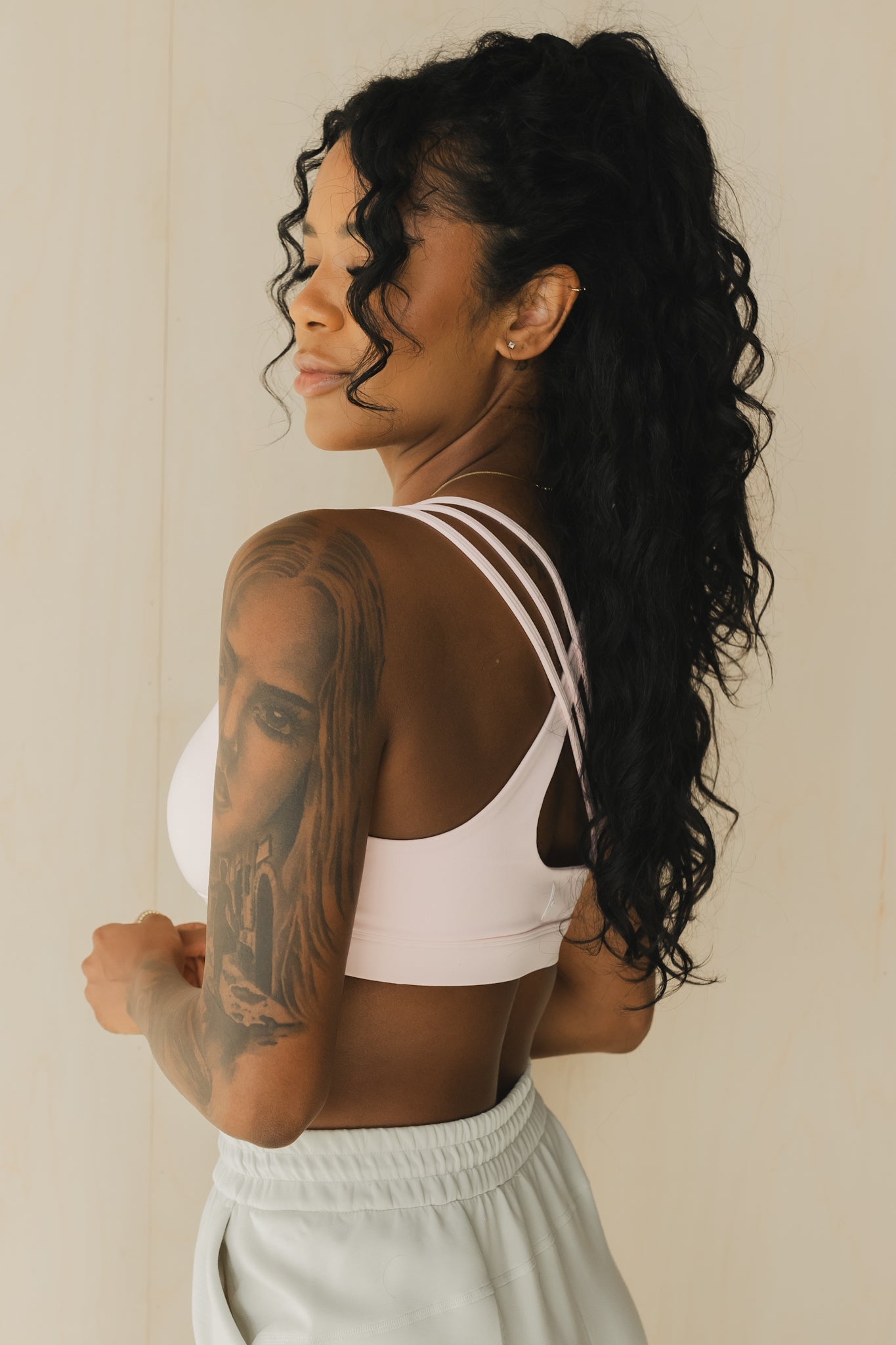 side view of a woman wearing S.F. V3 sports bra in pink lemonade for yoga and studio workouts