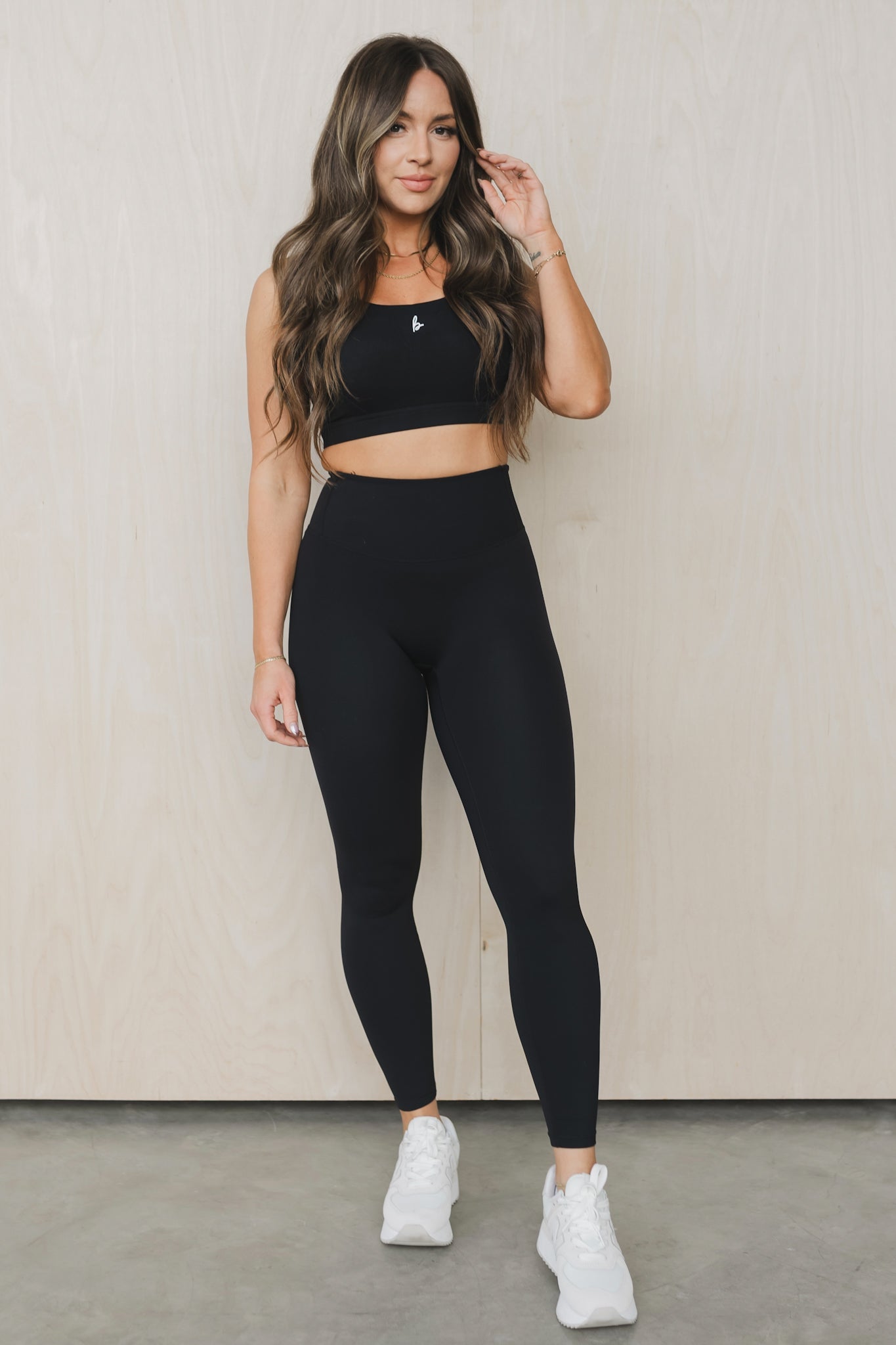front view of a woman wearing 27 inch fight or flight leggings in black for high impact training and everyday wear