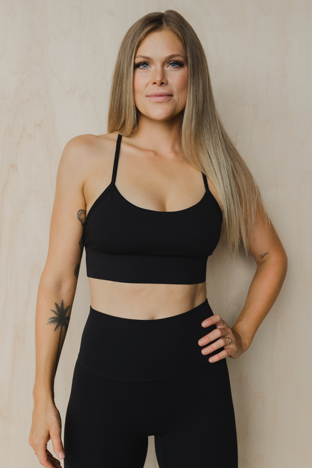 front view of a woman wearing a barely there sports bra in black for high impact training and everyday wear