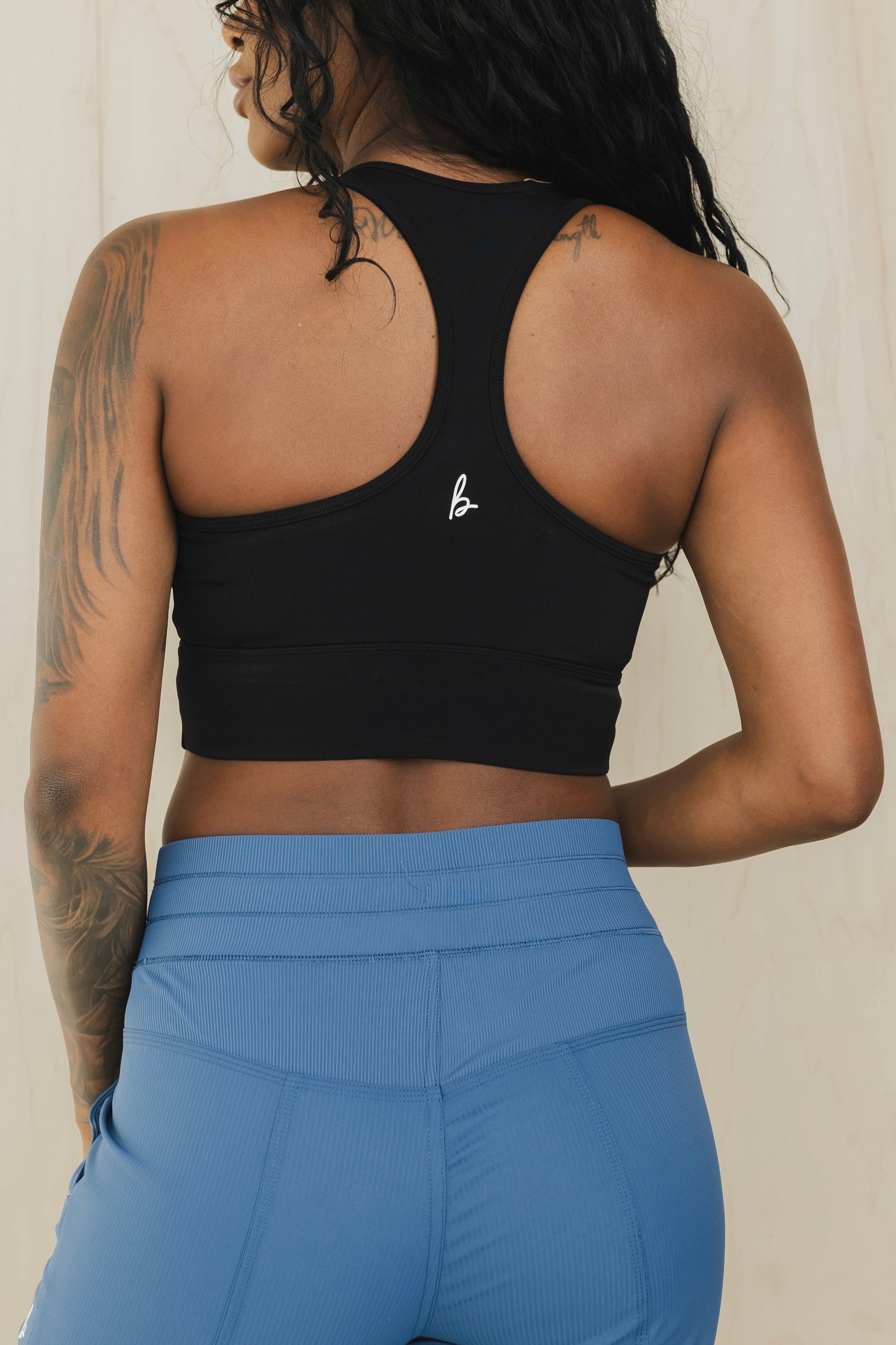 back view of racerback sports bra in black for yoga and fitness