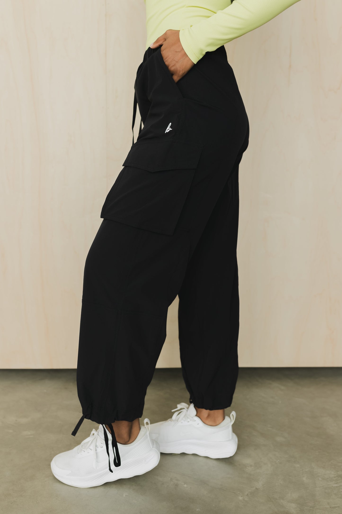 side view of a woman wearing cargo pant in black for streetwear and versatile everyday styling