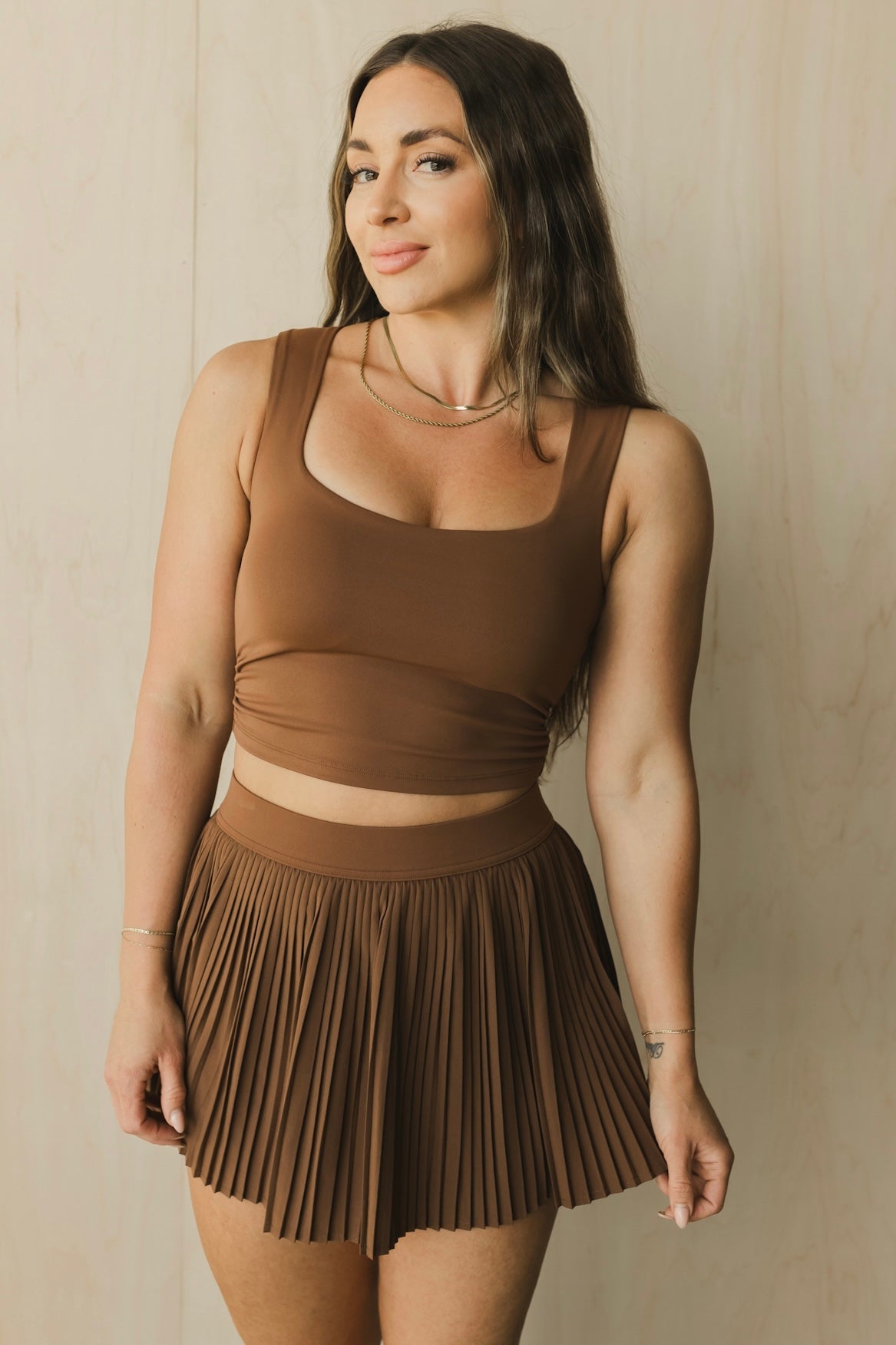 front view of a woman wearing a sweetheart tank top in earth brown for yoga and activewear