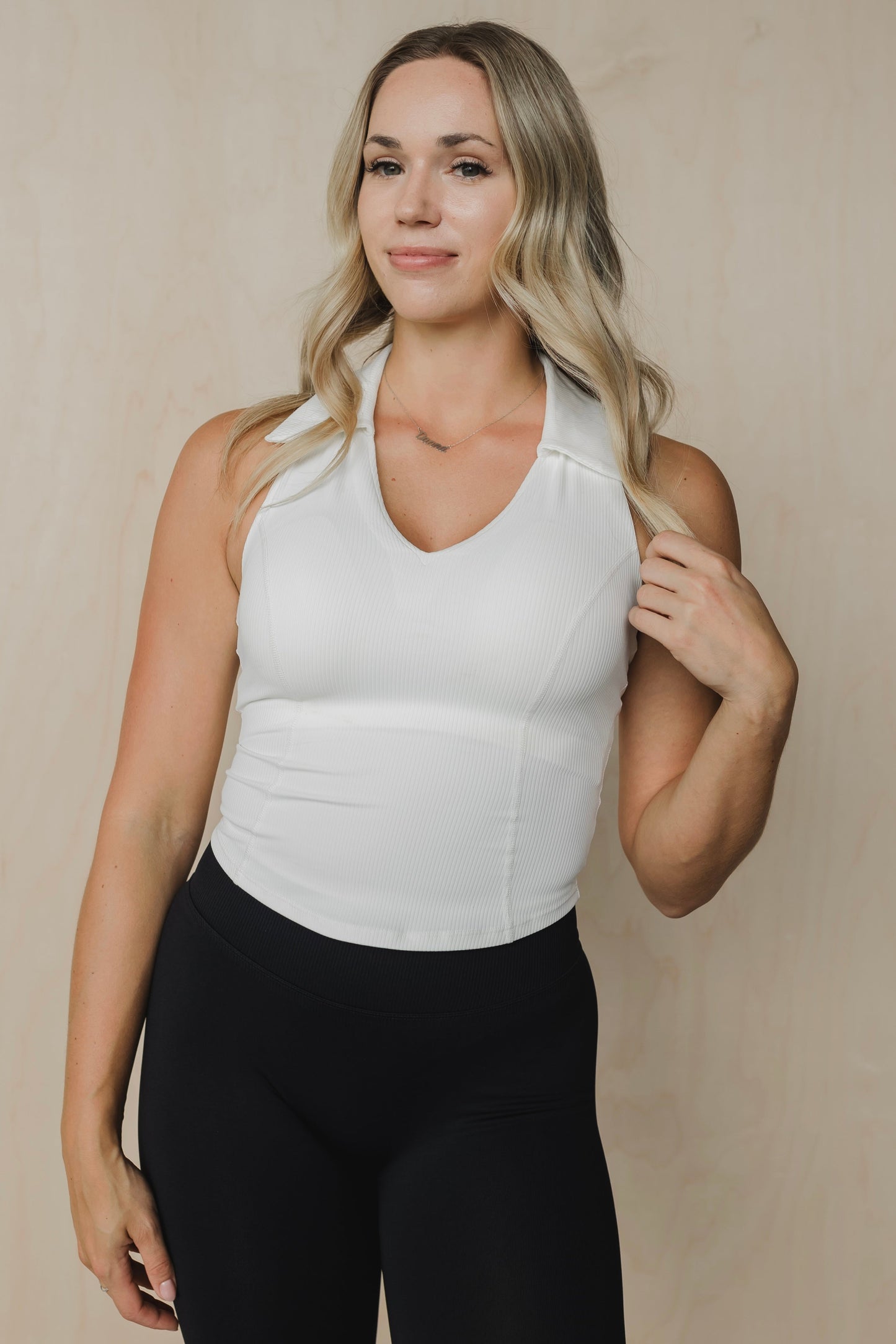 front view of a woman wearing a Ace tank top in white for golf yoga and activewear