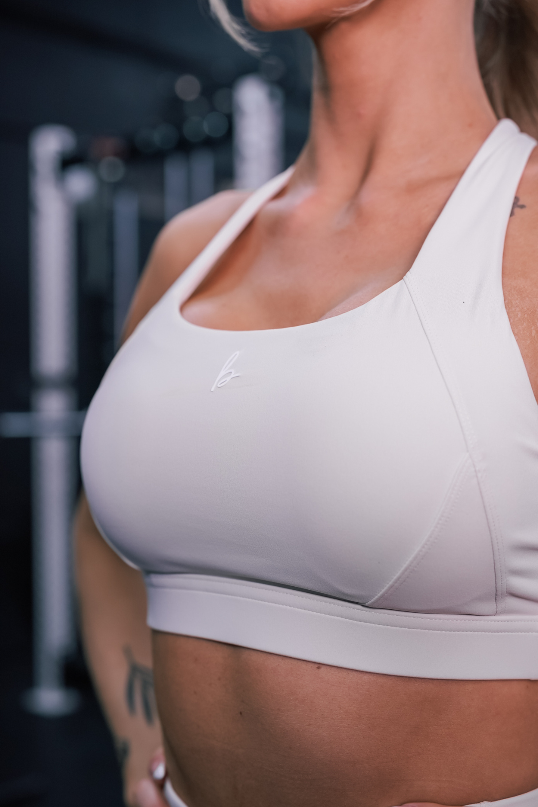 close up front view of a woman wearing a Fight or Flight high-support sports bra in sweet vanilla for yoga and fitness