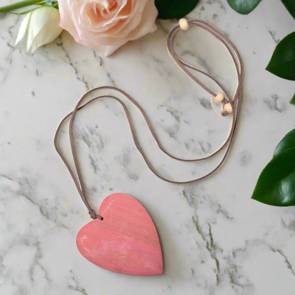 Pink tinted wood heart pendant — handcrafted natural wood necklace