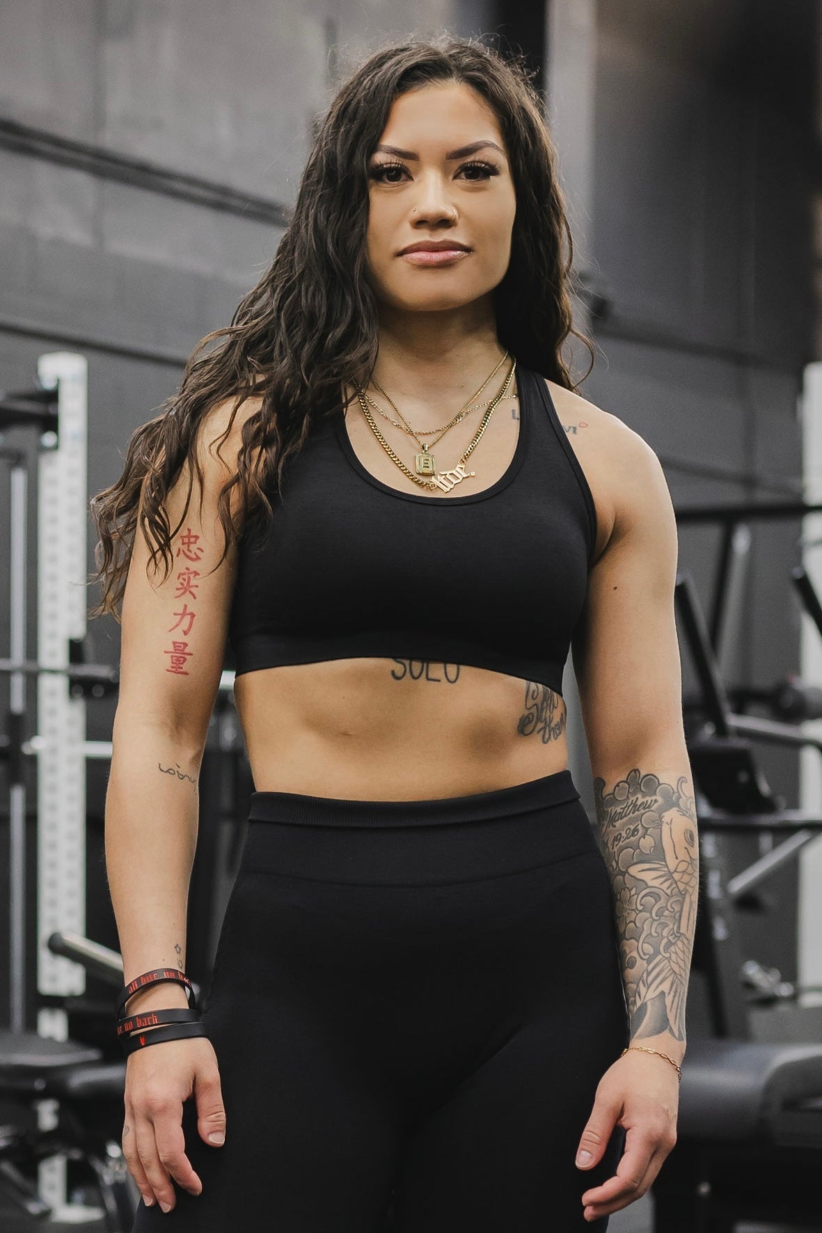 front view of a woman wearing a silhouette seamless sports bra in black with matching leggings for yoga and fitness