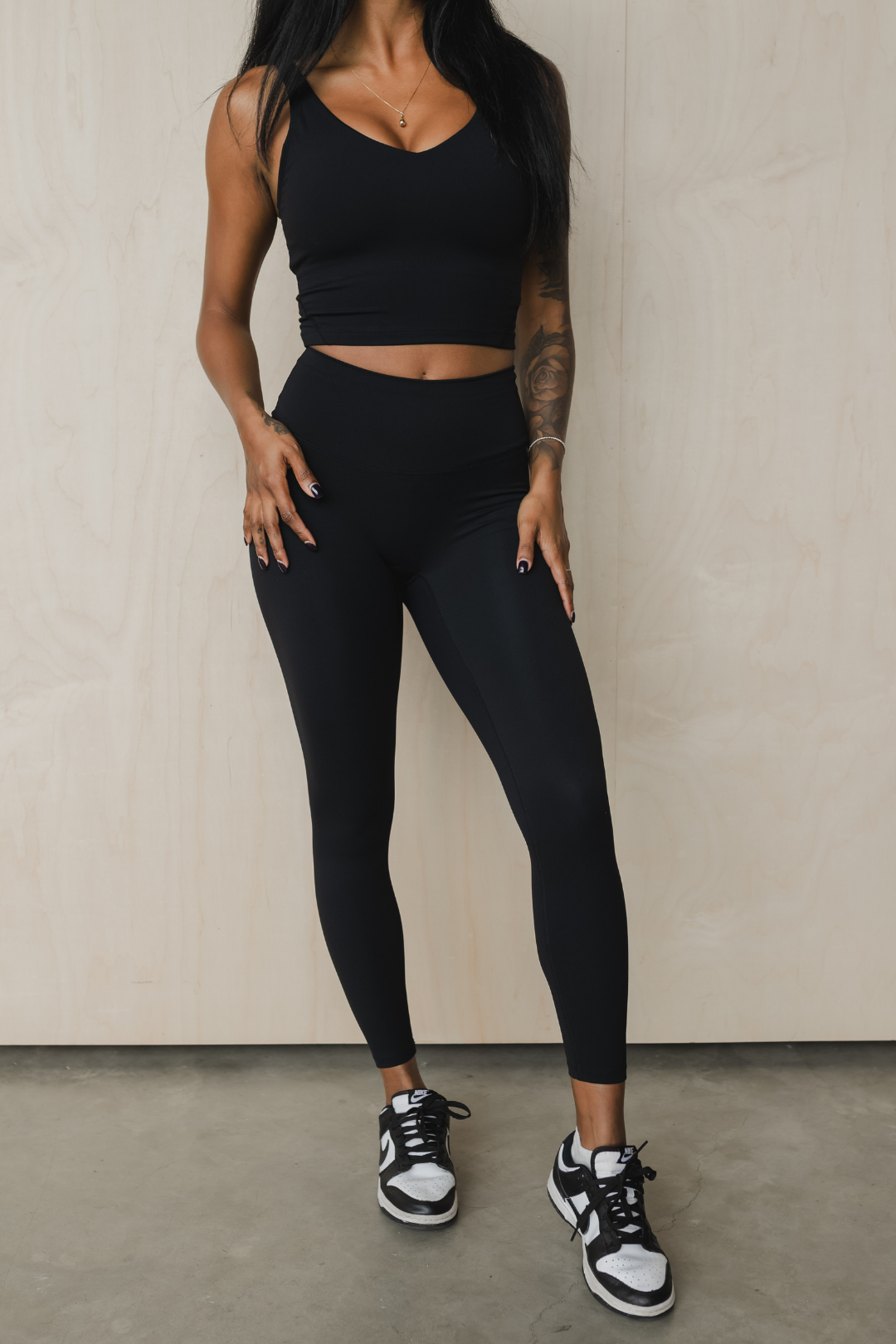 full front view of a woman wearing 25 inch barely there leggings in black for loungewear and athletic wear