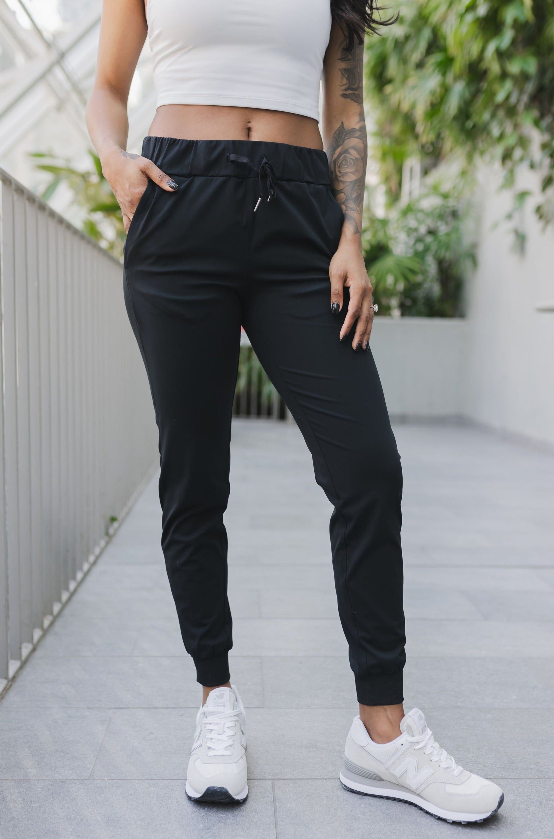 front view of a woman wearing cuffed ankle jogger in black camo for streetwear and everyday wear