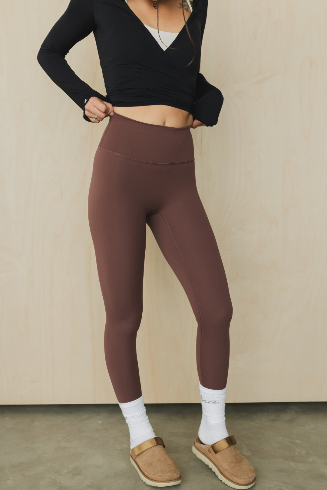 front view of a woman wearing running pant in russet for running and casual athletic wear