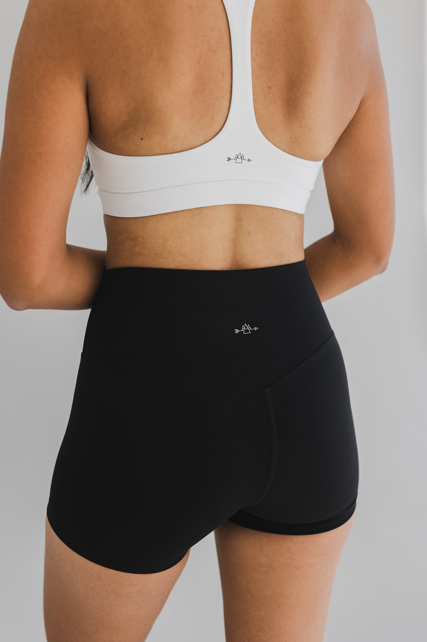 back view of woman wearing barely There 4" yoga shorts in black, lightweight squat-proof activewear