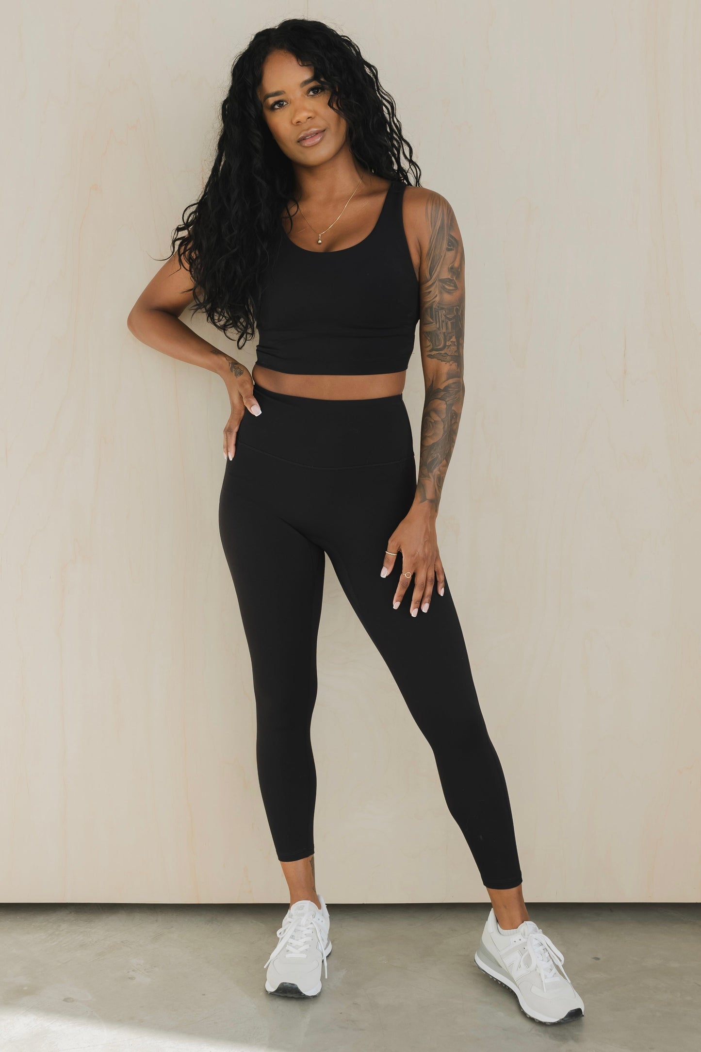 front view of a woman wearing prana yoga pant in black for hot yoga and mindful movement