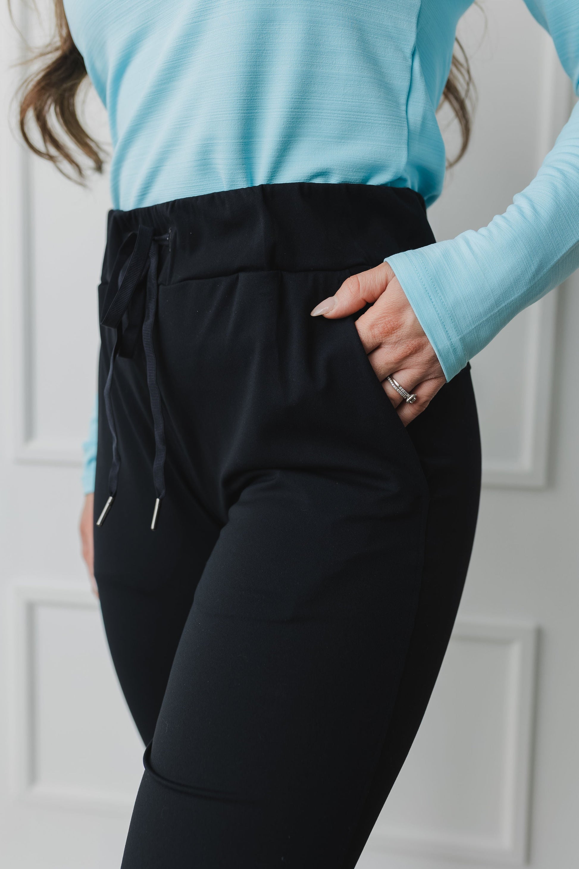close up view of a woman wearing cuffed ankle jogger in black for loungewear and casual athleisure 