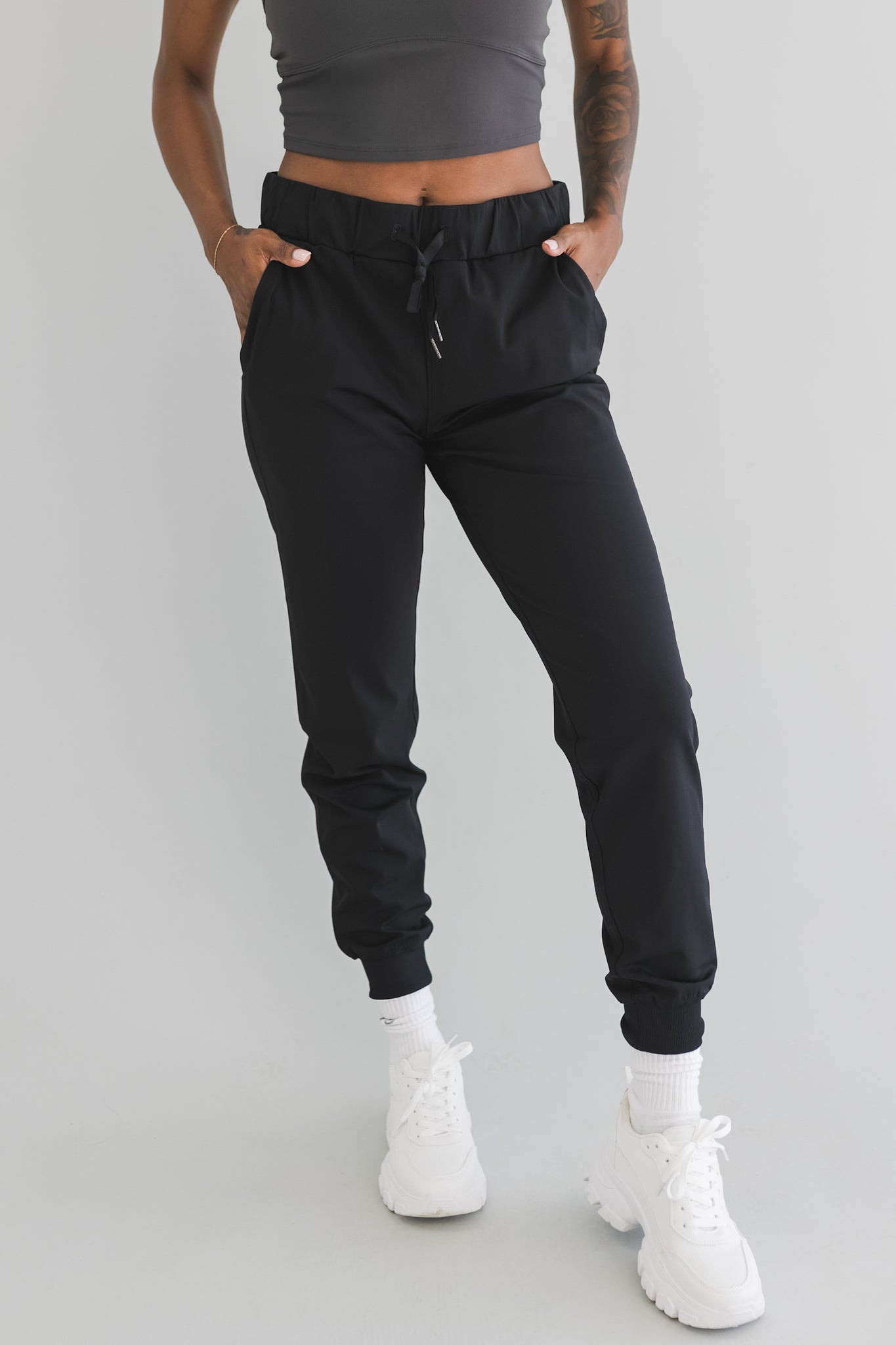 close up front view of a woman wearing cuffed ankle jogger in black camo for streetwear and everyday wear