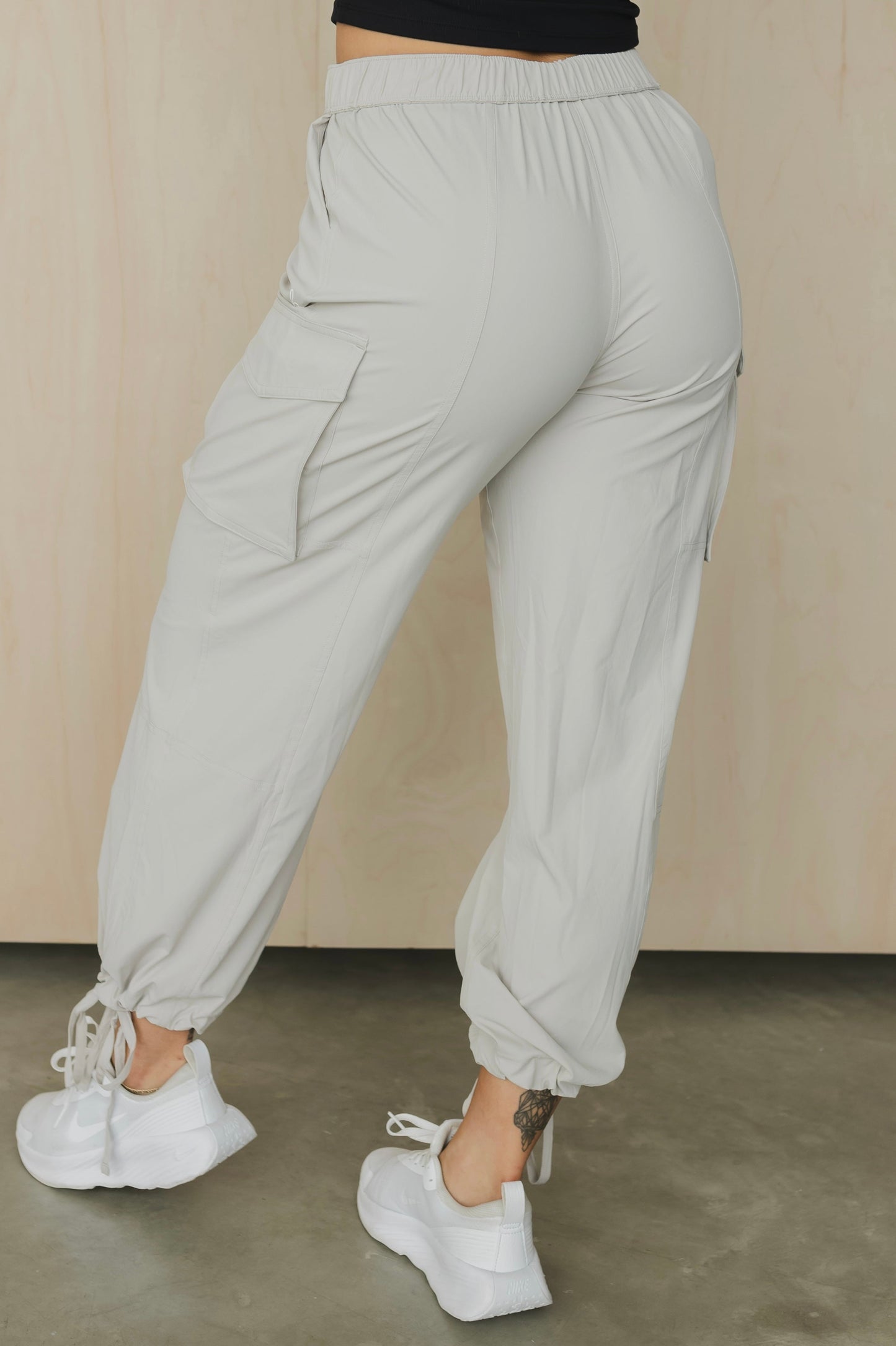 back view of a woman wearing cargo pant in birch bark for outdoor wear and casual athleisure