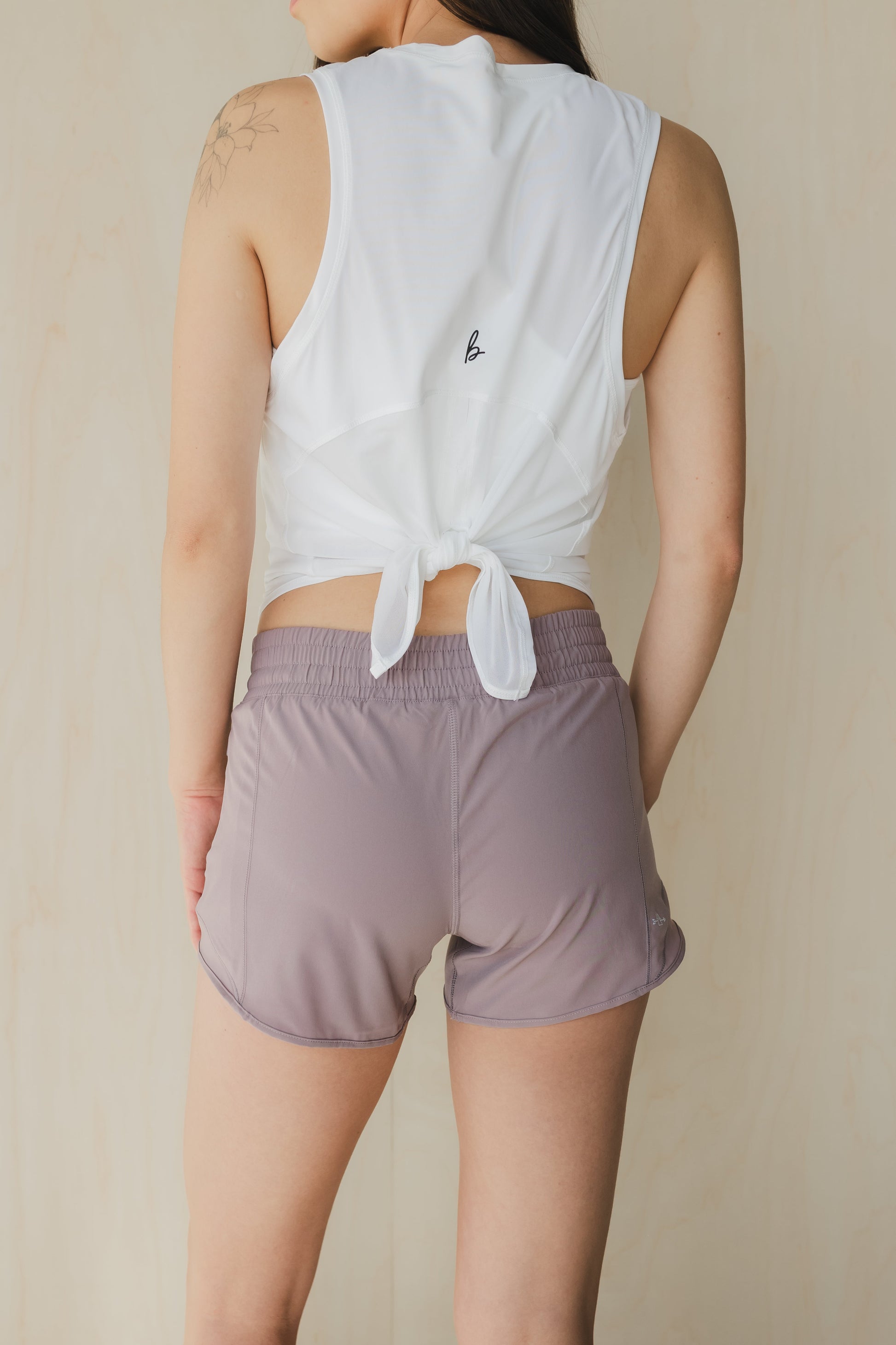 back view of woman wearing Ready for It shorts in amethyst grey for workouts and casual wea