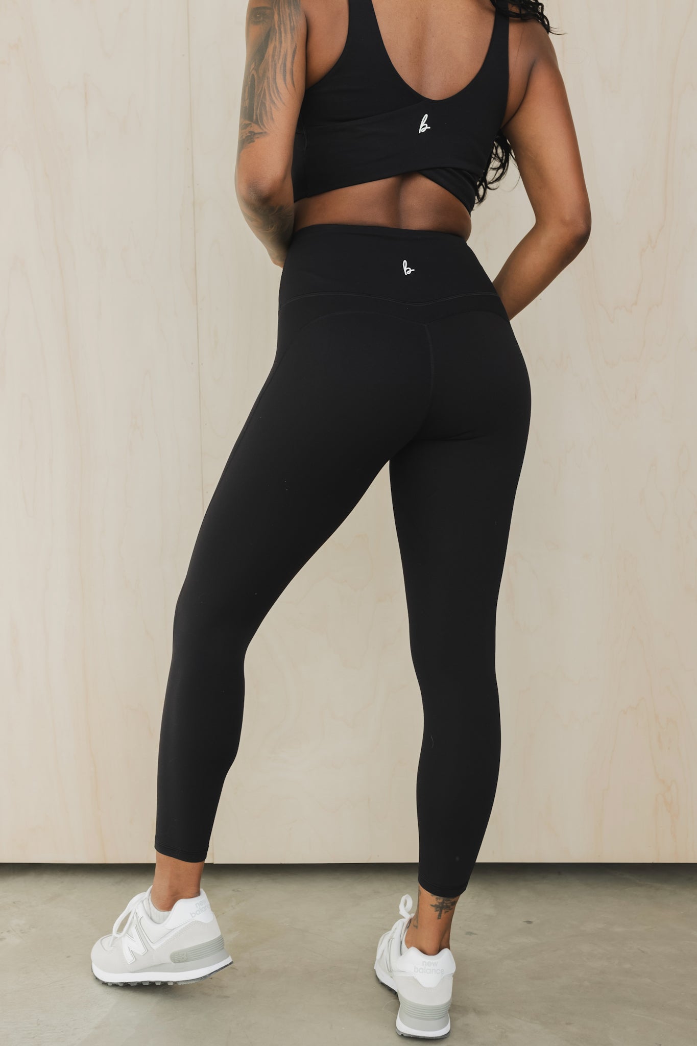 zommed out back view of a woman wearing prana yoga pant in black for hot yoga and mindful movement