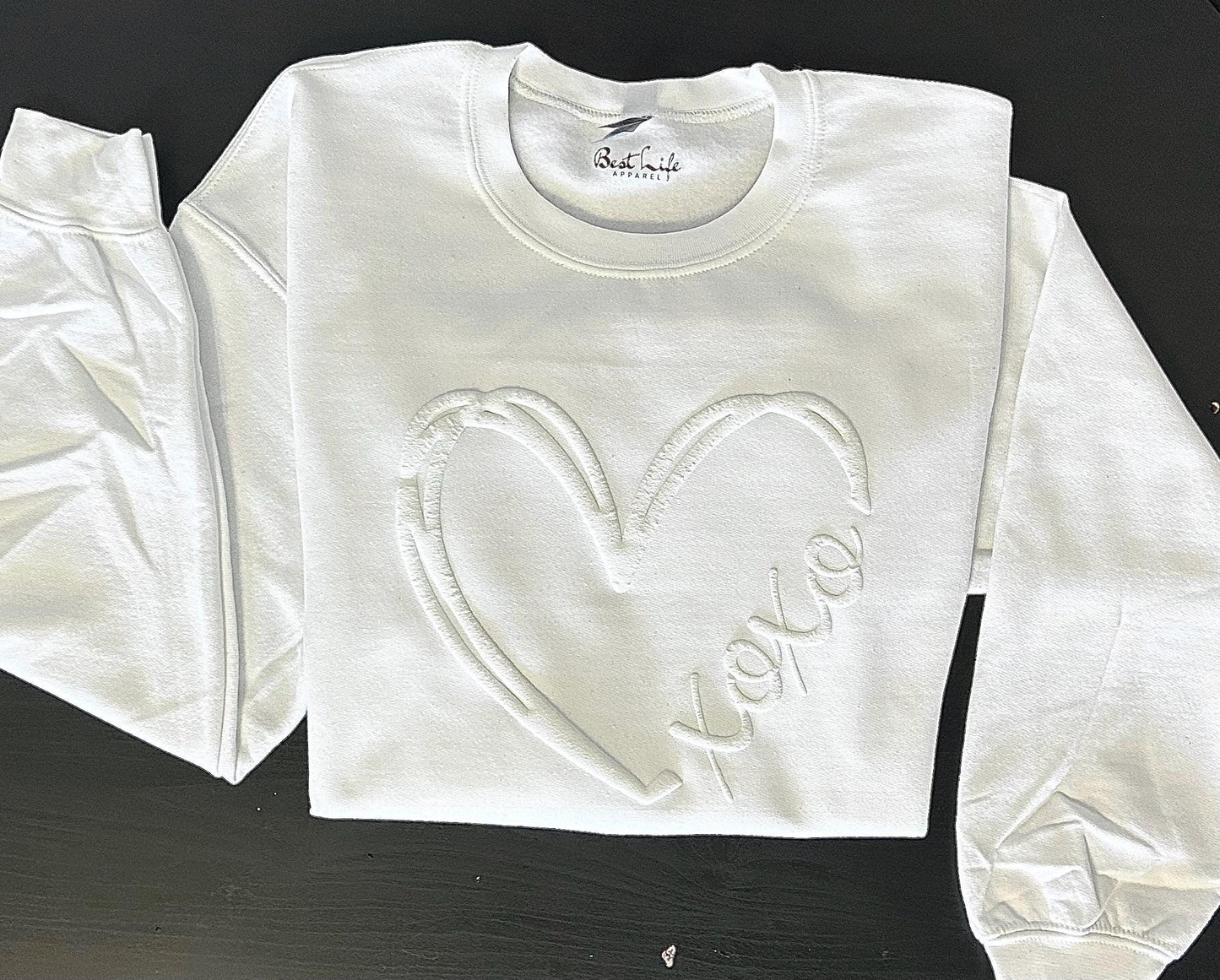 XOXO Embossed Heart sweatshirt close-up showing embossed texture and print detail