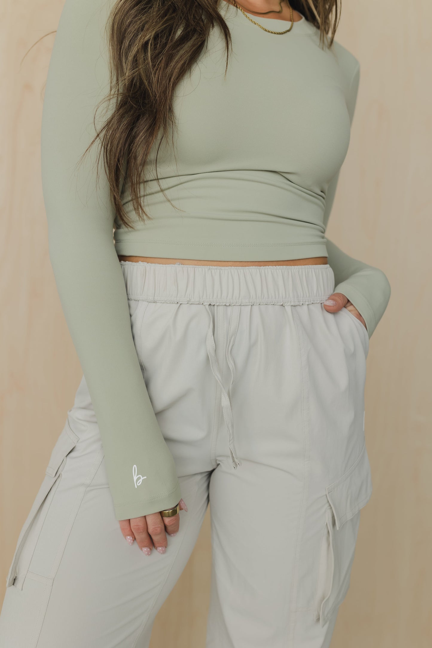zoomed in front view of a woman wearing cargo pant in birch bark for outdoor wear and casual athleisure