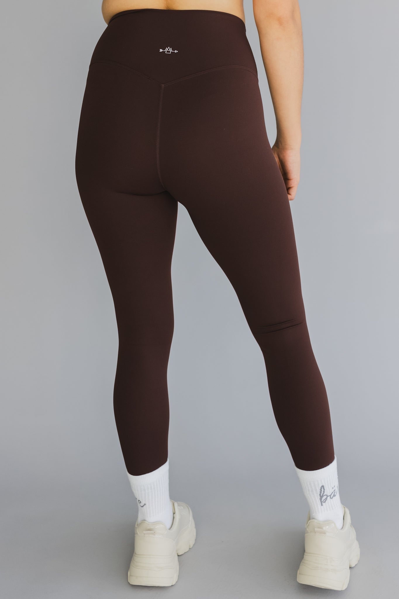 back view of a woman wearing 25 inch barely there leggings in coffee for pilates and casual athleisure