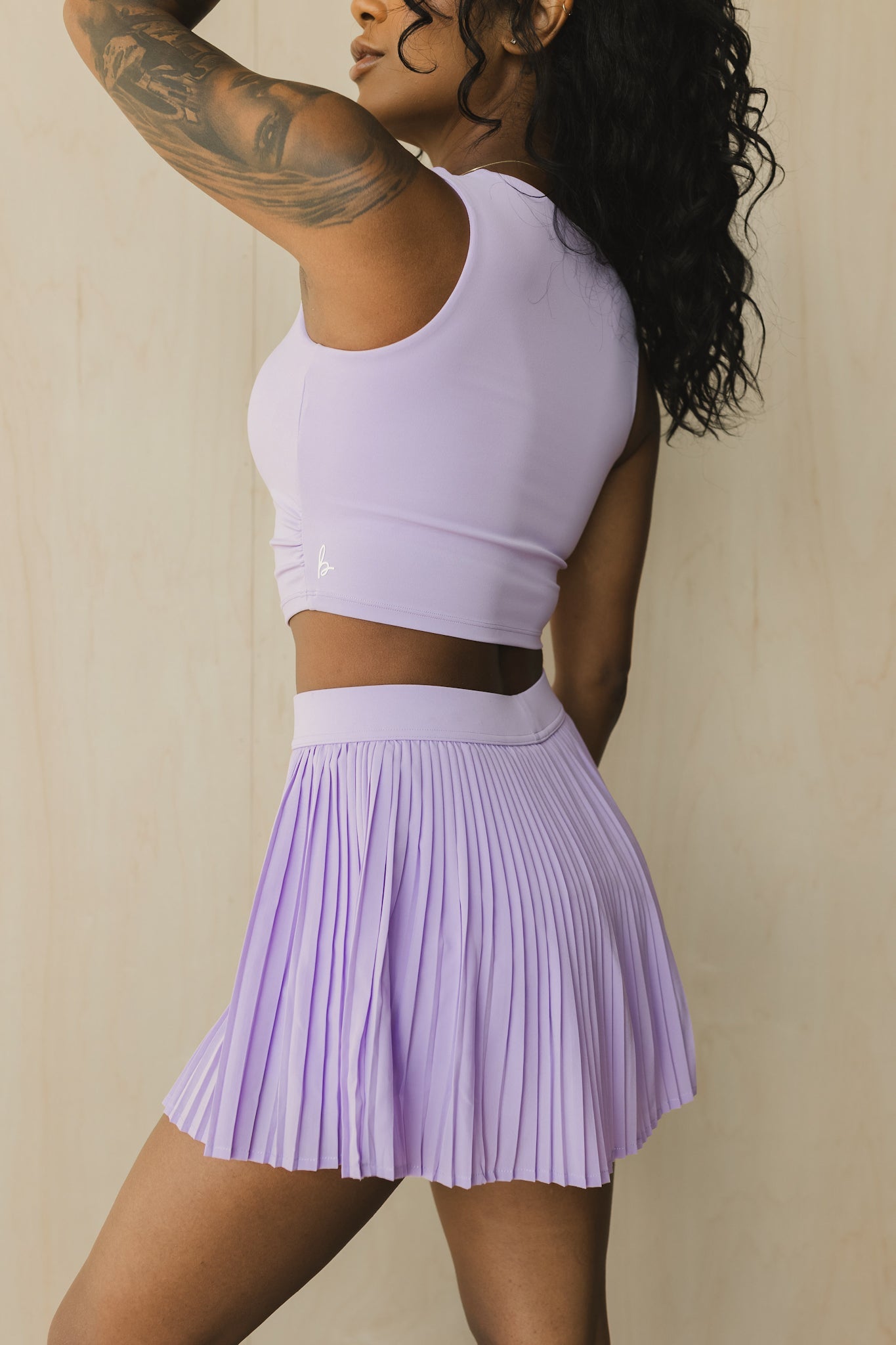 side view of a woman wearing a sweetheart tank top in light lilac for yoga and activewear