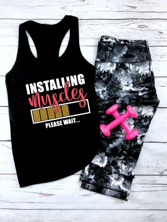 Hilarious "Installing Muscles Please Wait" racerback tank top for gym-loving women in black