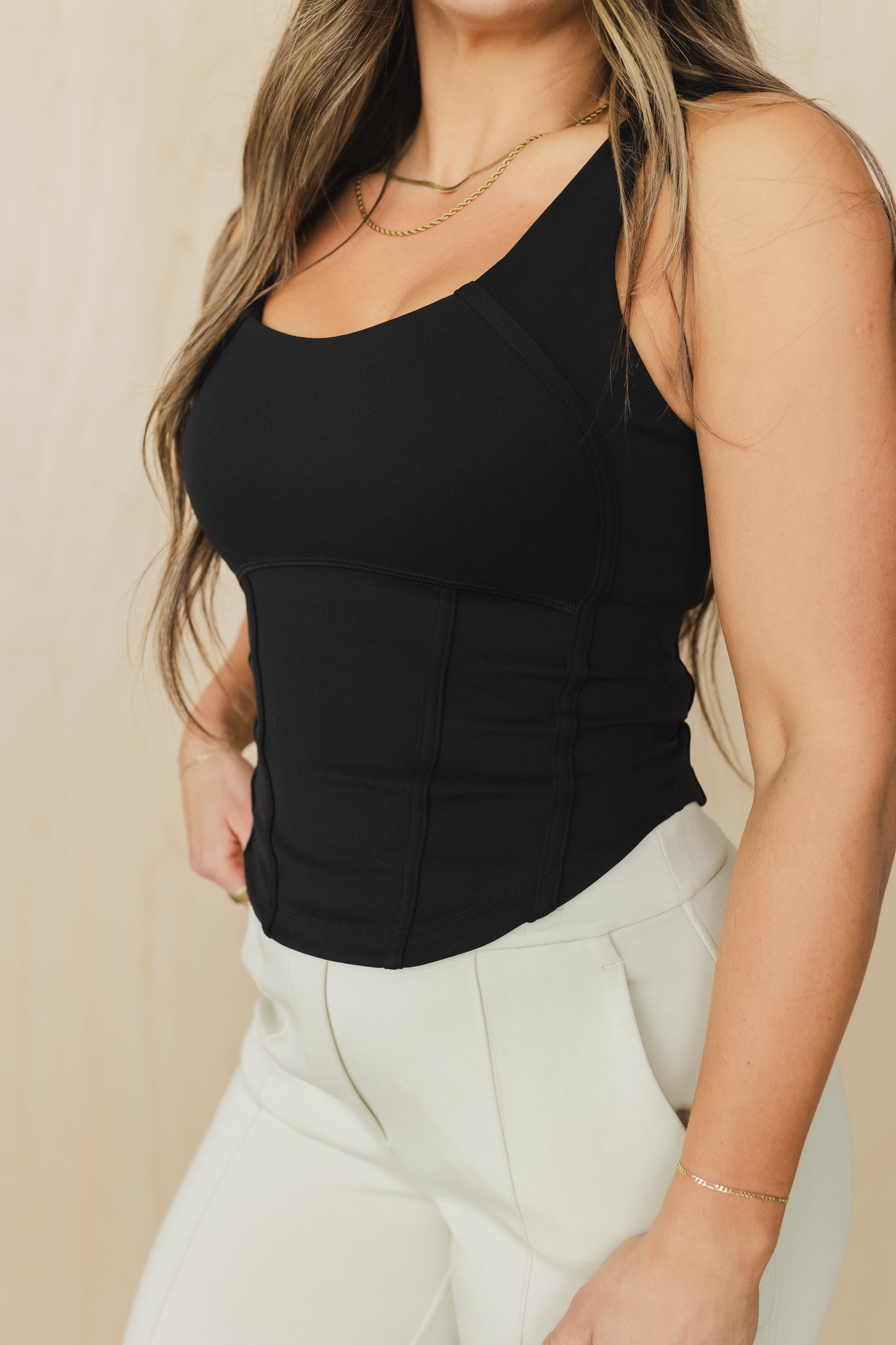 front view of a woman wearing a soft corset waist cincher in black for casual everyday wear