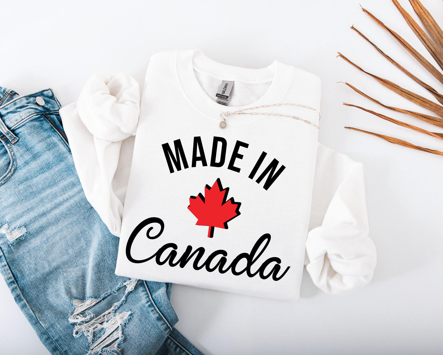 Women's Canadian pride sweatshirt with bold "Made in Canada" graphic print in white