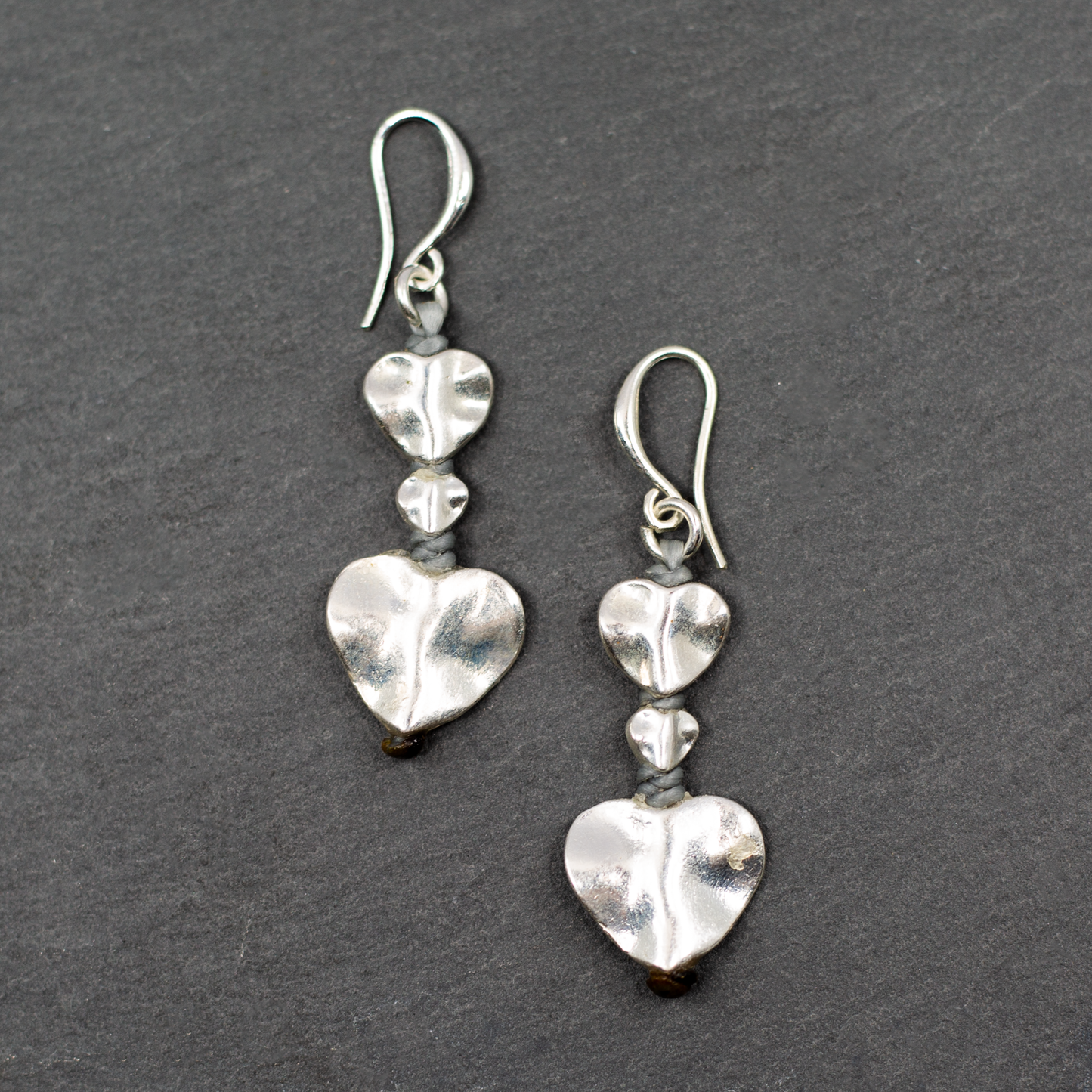 Silver plate double drop heart earrings dangle romantic jewelry on dark background