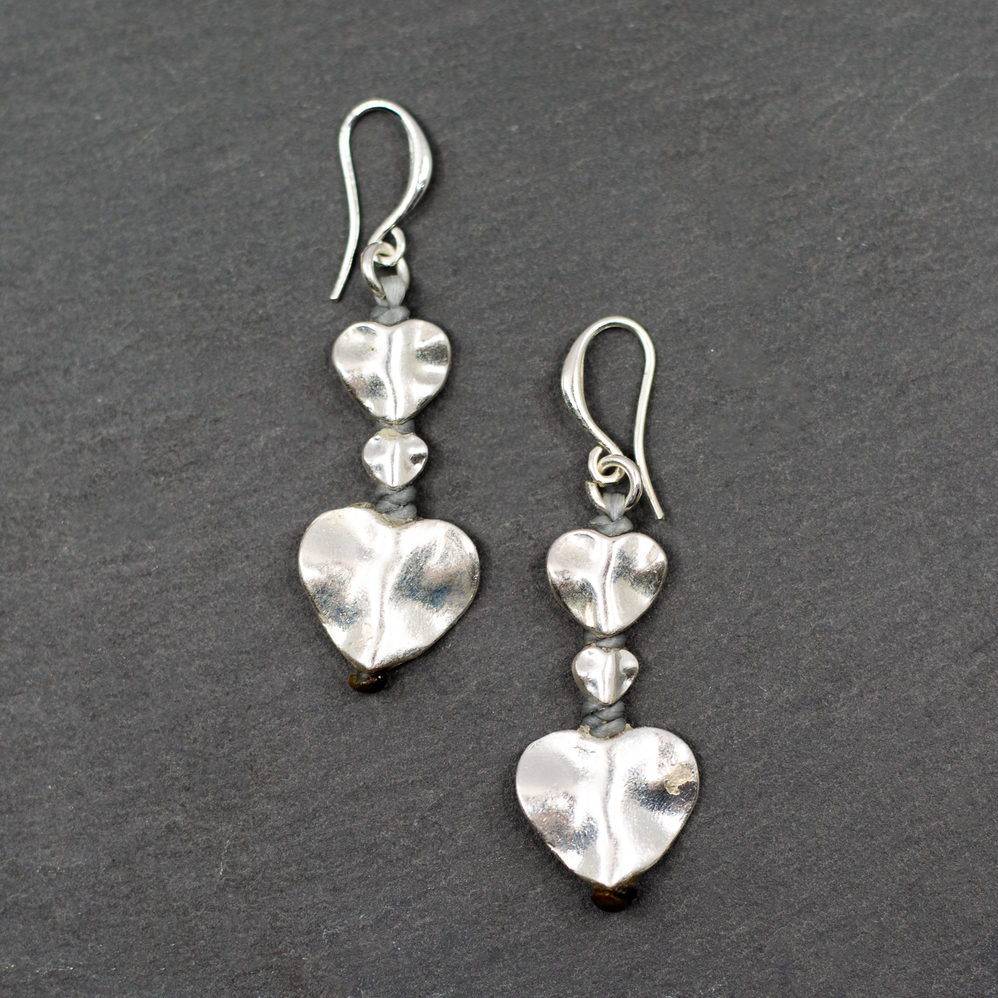 Silver plate double drop heart earrings dangle romantic jewelry on dark background