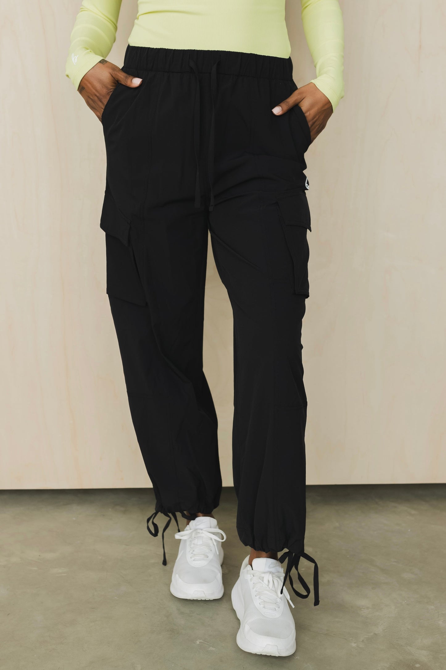 front view of a woman wearing cargo pant in black for streetwear and versatile everyday styling