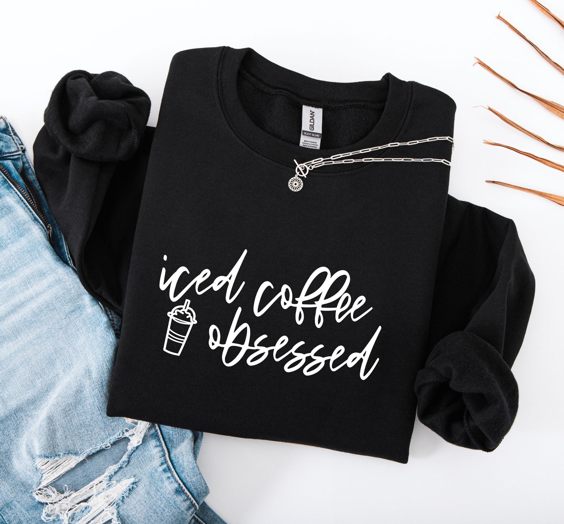 Women's funny iced coffee sweatshirt with bold and relatable graphic print on black