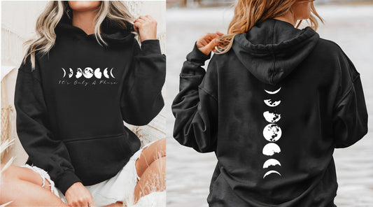 Celestial "It's Only A Phase" moon phases hoodie for spiritual and mindful women in black front and back view