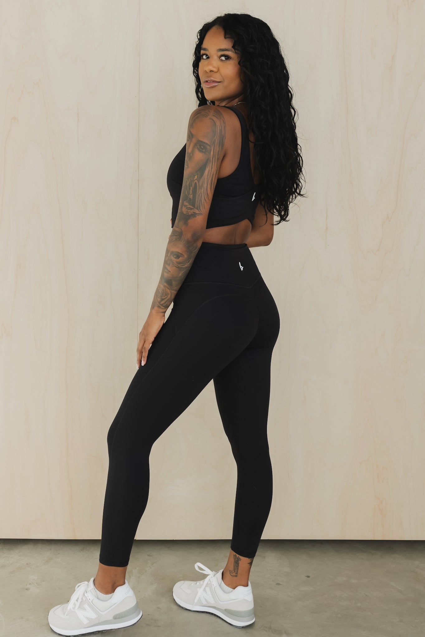 full body side view of a woman wearing prana yoga pant in black for hot yoga and mindful movement