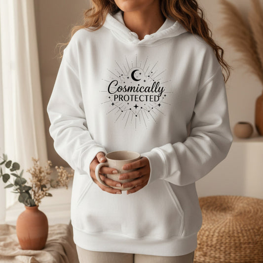 White cosmically protected hoodie with black celestial sunburst print — clean ethereal spiritual gift for the woman who carries quiet faith and cosmic energy into every room