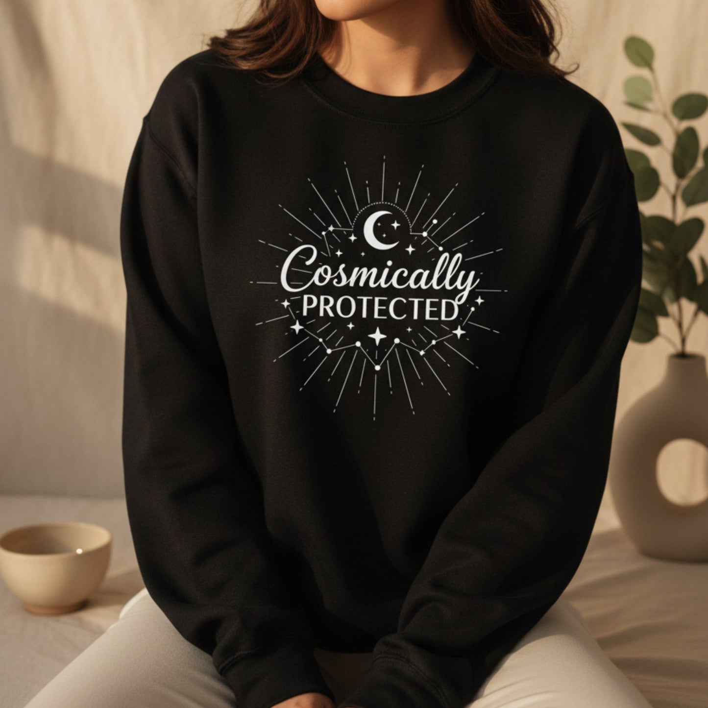 Black cosmically protected sweatshirt with white moon and sunburst print — witchy spiritual gift for her, cozy celestial pullover for dark academia and lunar energy lovers
