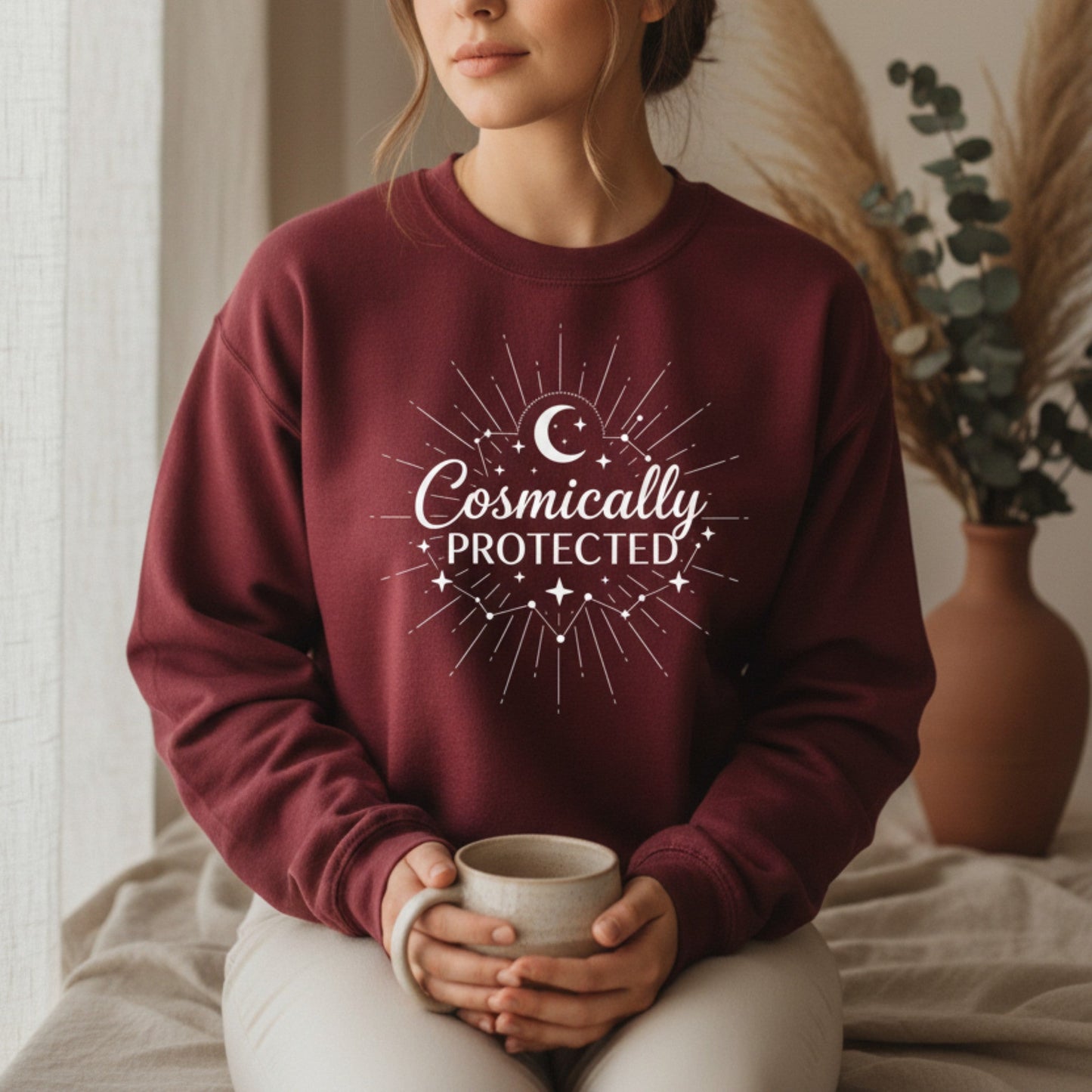 Maroon crewneck with white celestial protection graphic — mystical moon gift for the spiritual woman who knows she is watched over by something greater